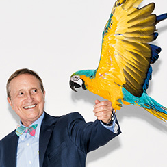 Picture of biologist Thomas Lovejoy with a parrot