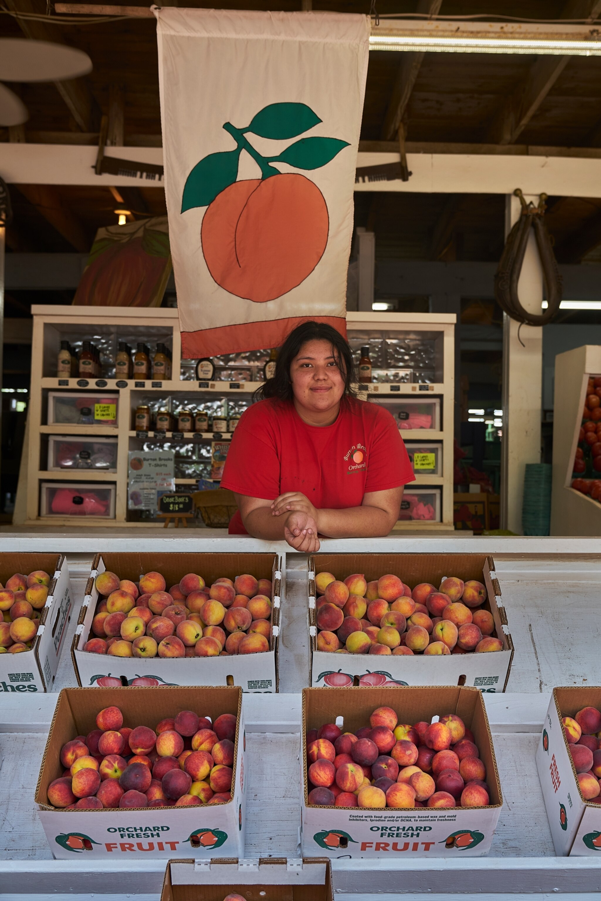 jessica lamas-bravos working at a peach stand