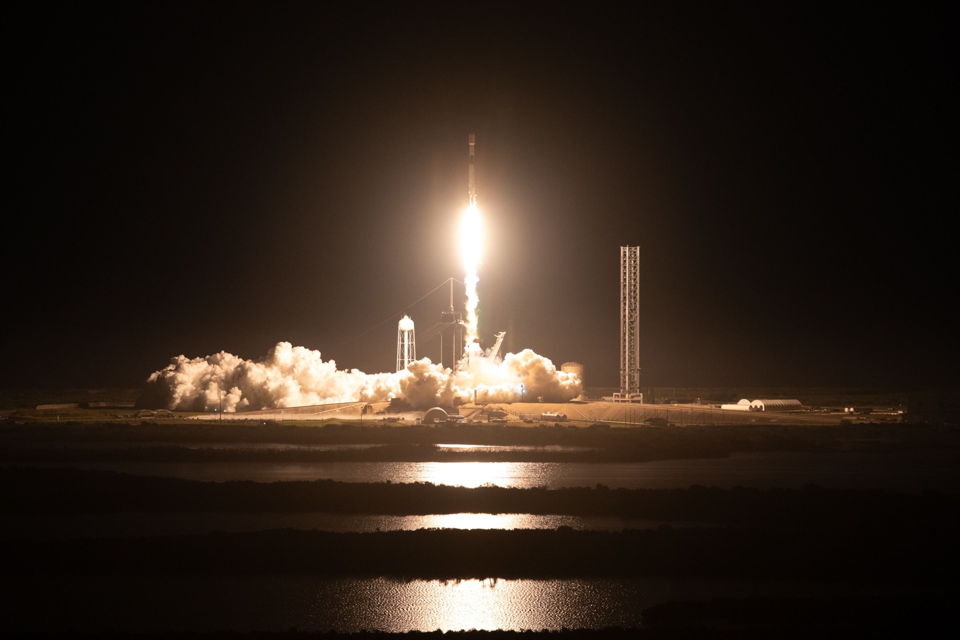A SpaceX Falcon 9 rocket launching from NASA’s Kennedy Space Center at night.