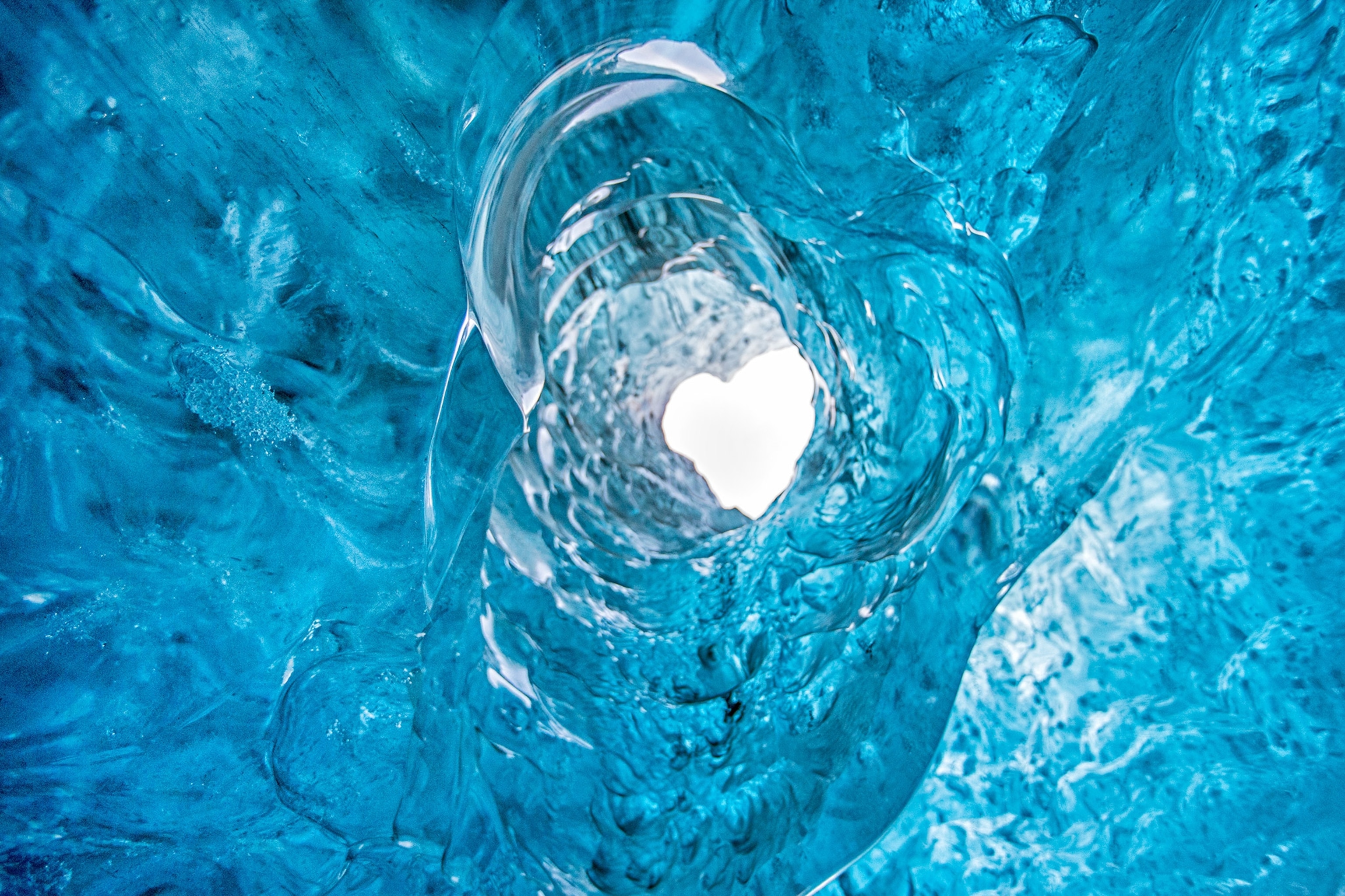 a heart-shaped void from inside a glacial cave in Jokulsarlon, Iceland