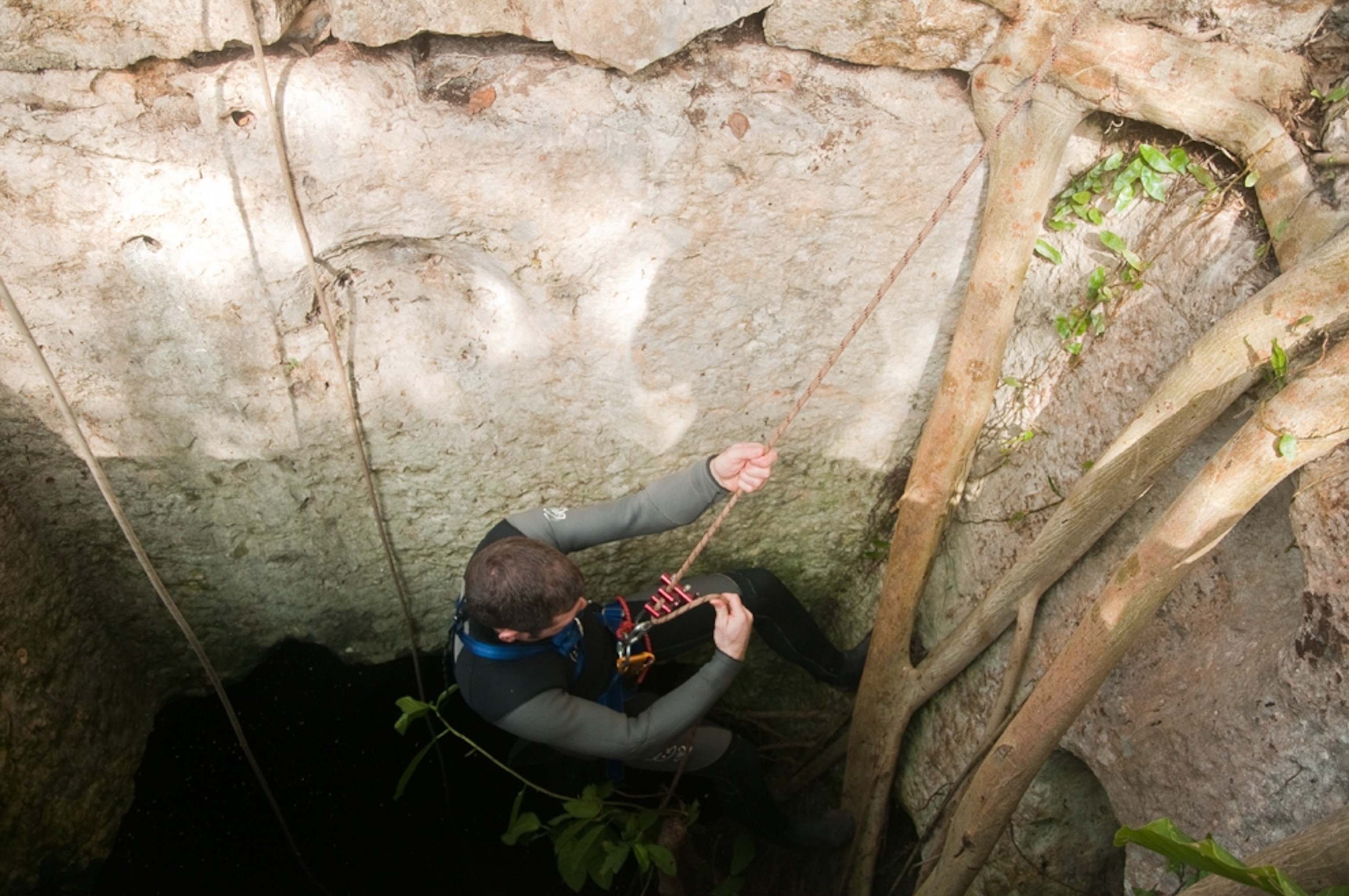 Maya sacrifice picture: A researcher descending into a cenote in Mexico