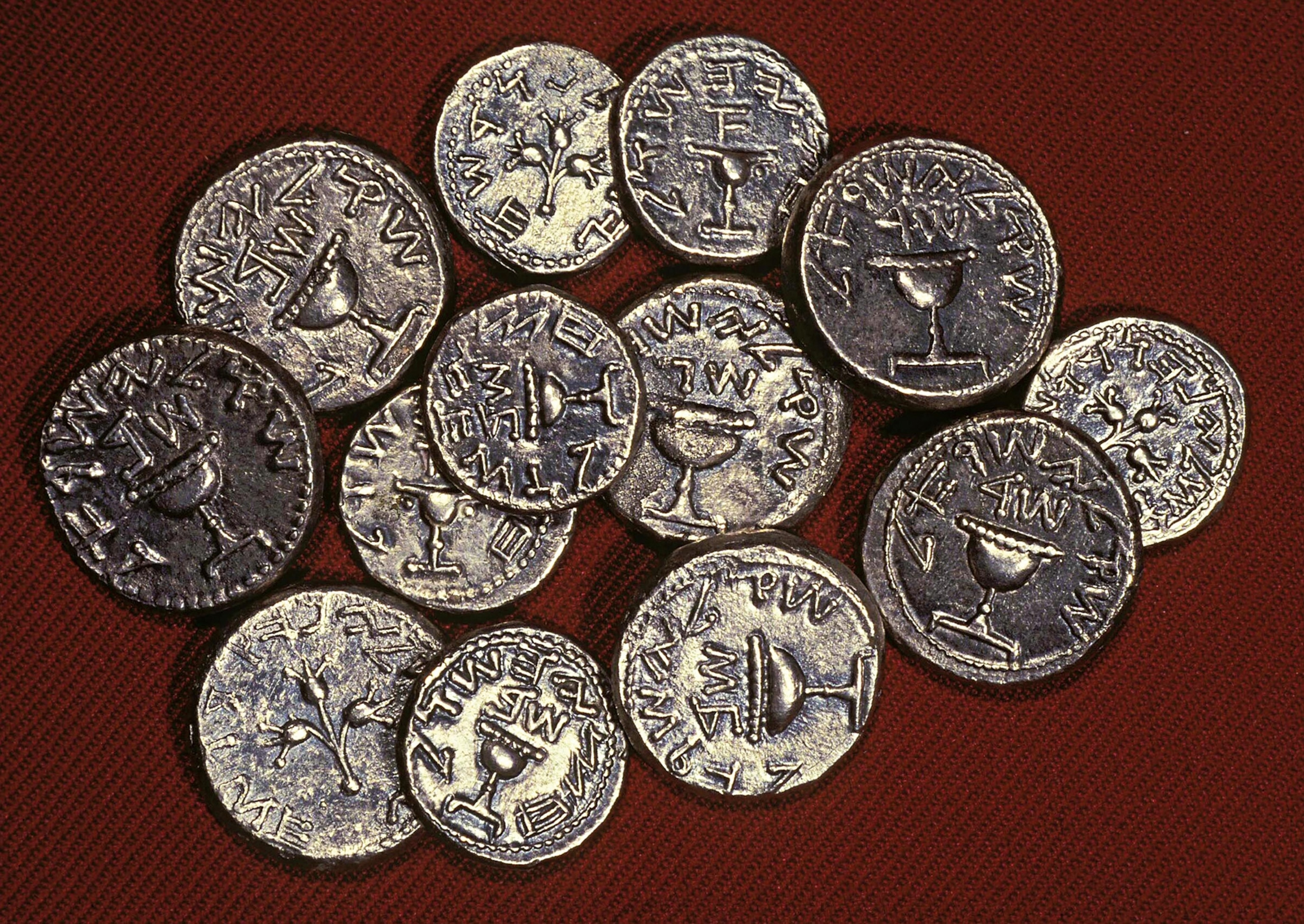 A collection of Jewish and Tyrian shekels illustrates the 30 pieces of silver paid to Judas for his betrayal of Jesus.