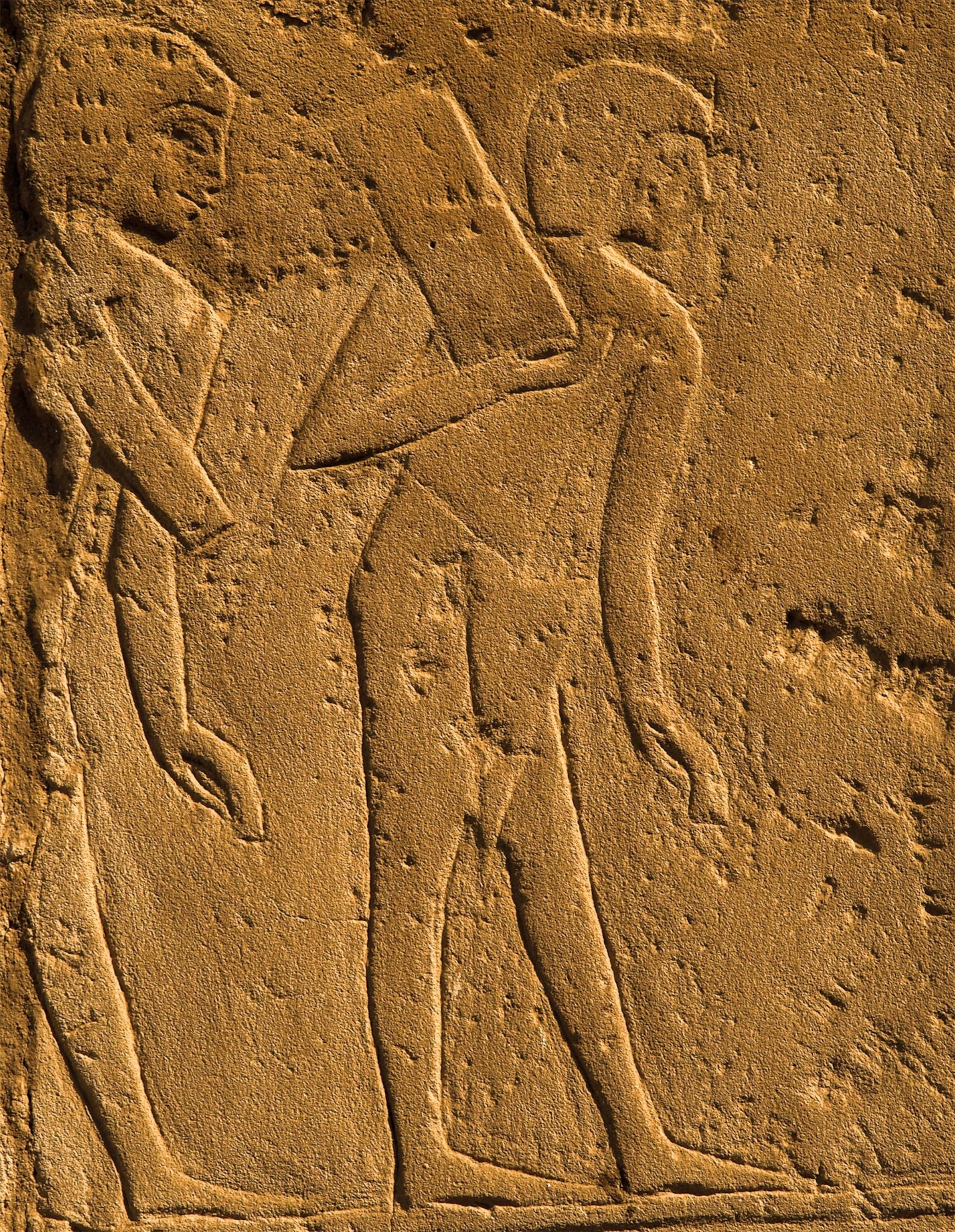Construction workers carry sandstone blocks in a relief detail from the Temple of Luxor