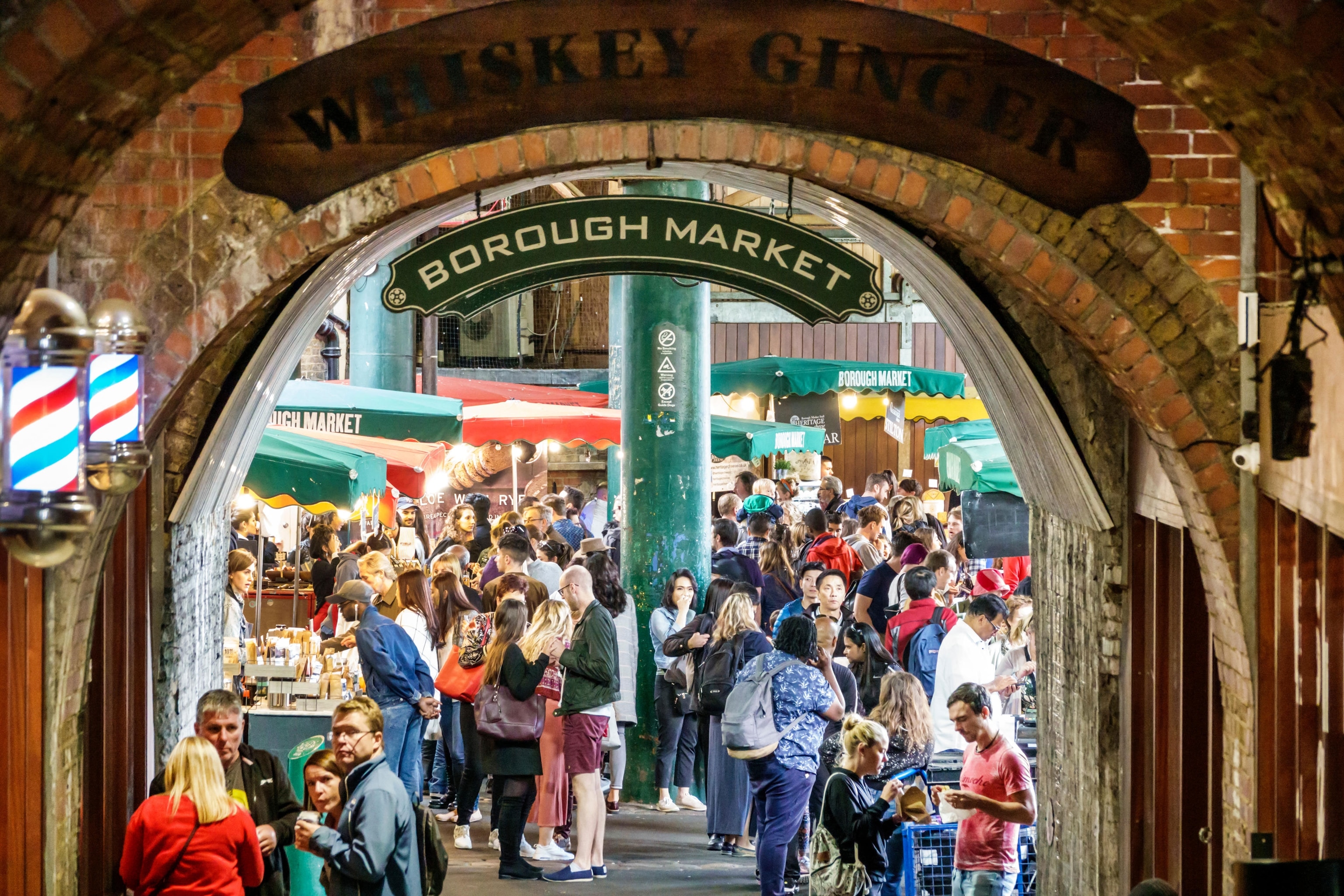 underneath bridge archway, with views on market-goers in the distance
