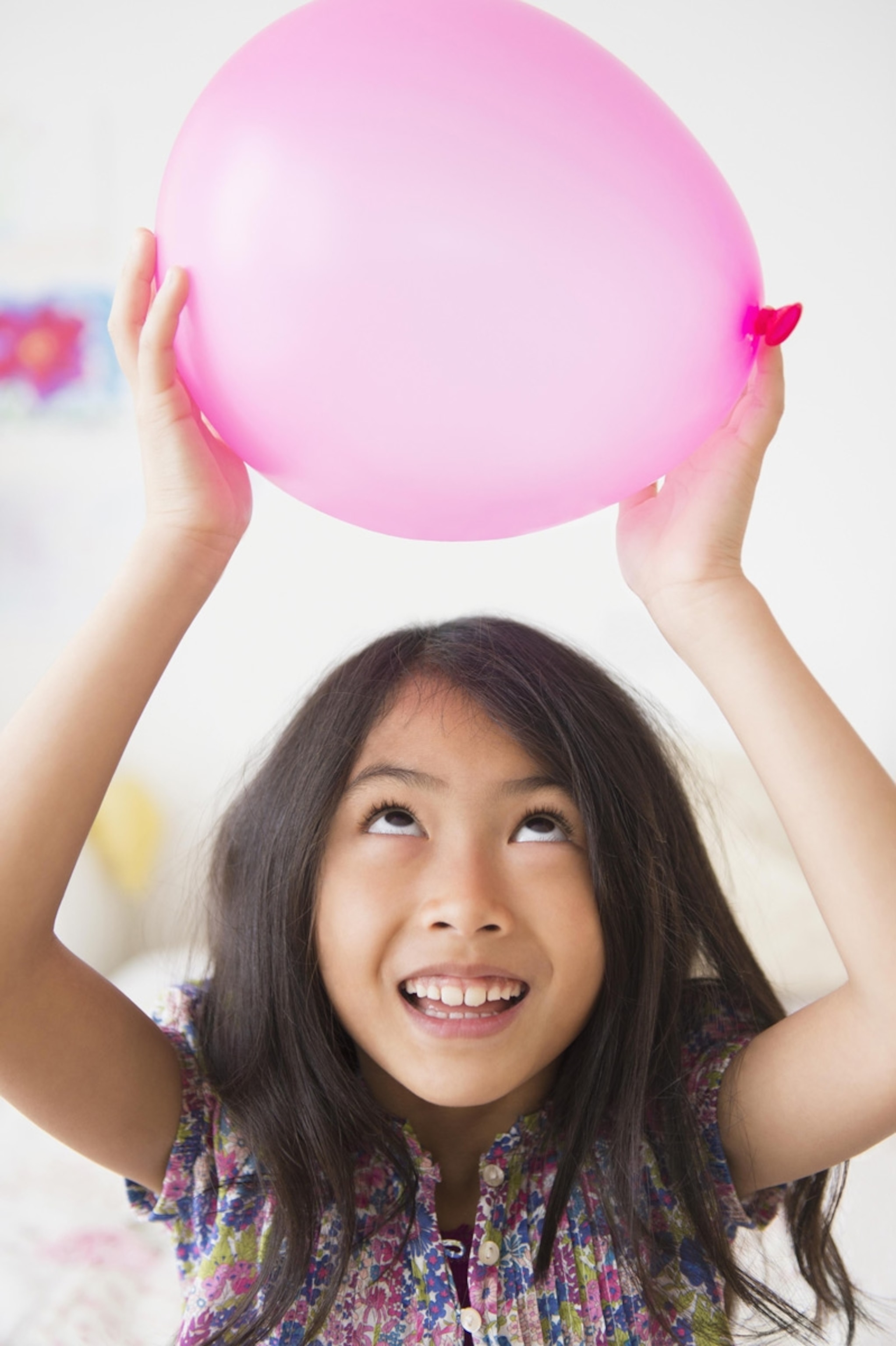 Vietnamese girl holding pink balloon. New Jersey