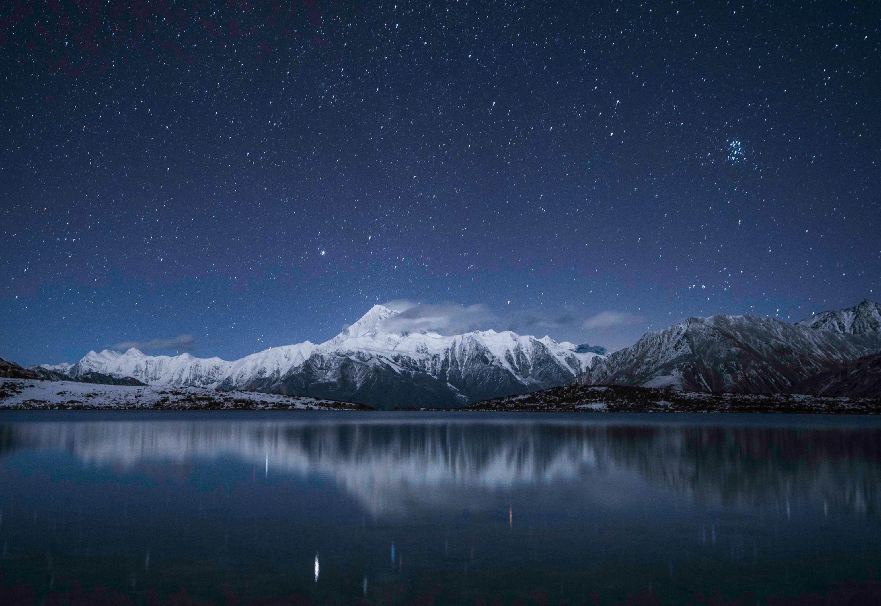 Photo of mountain against night sky full of stars