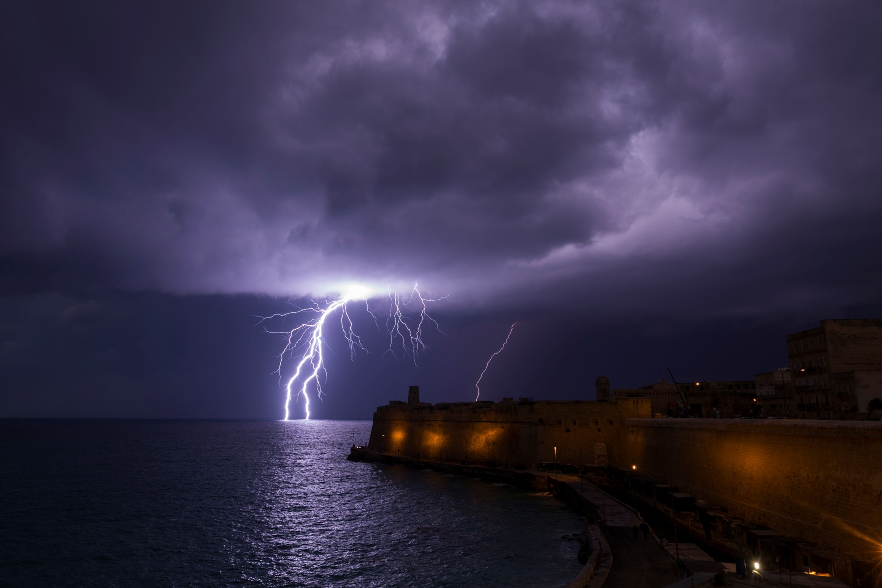 A lightning bolt strikes the sea near Fort St Elmo in Valletta, Malta
