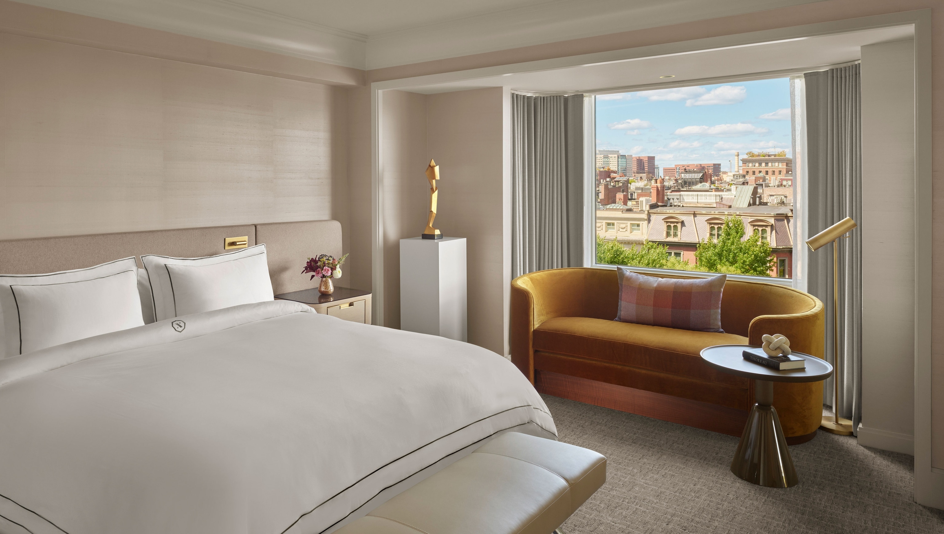 interior of hotel room, white sheets, cream walls and window