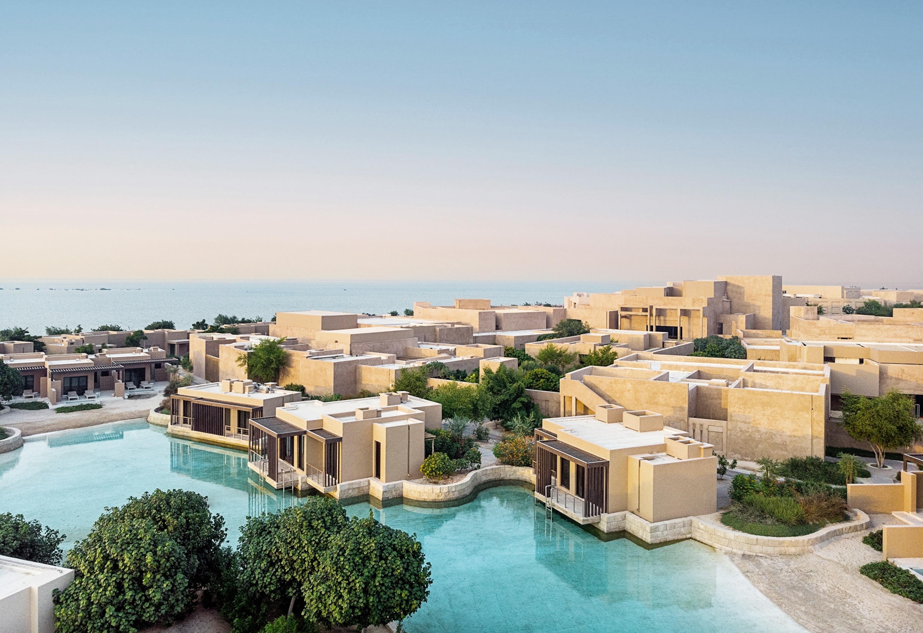 Aerial of Zulal Wellness Resort surrounded by the water.