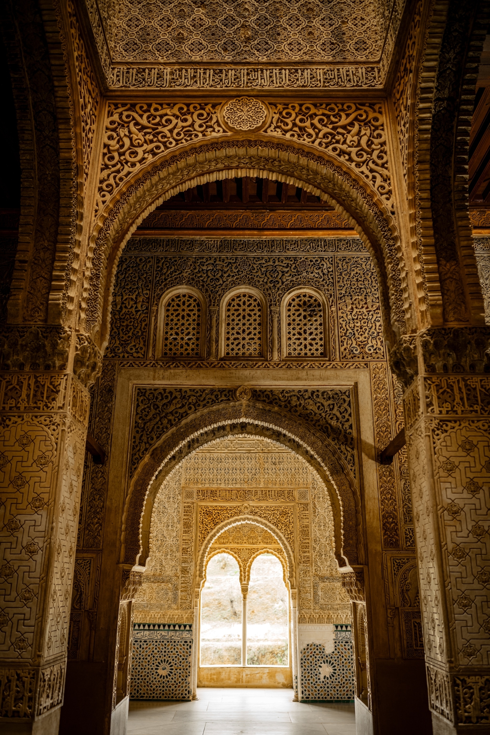 Enfilade of small rooms with tall arched ceilings.