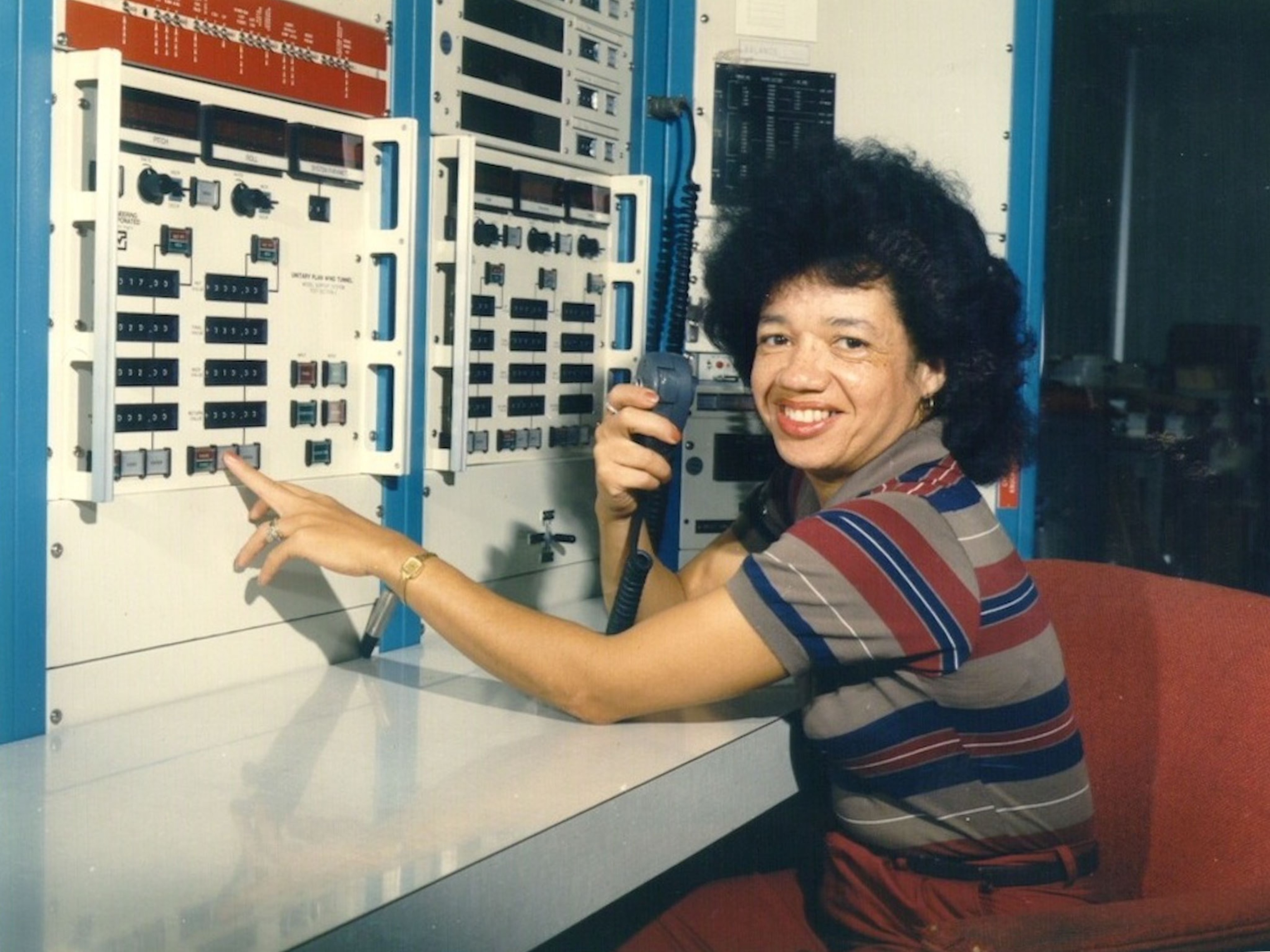 a woman in a NASA control room