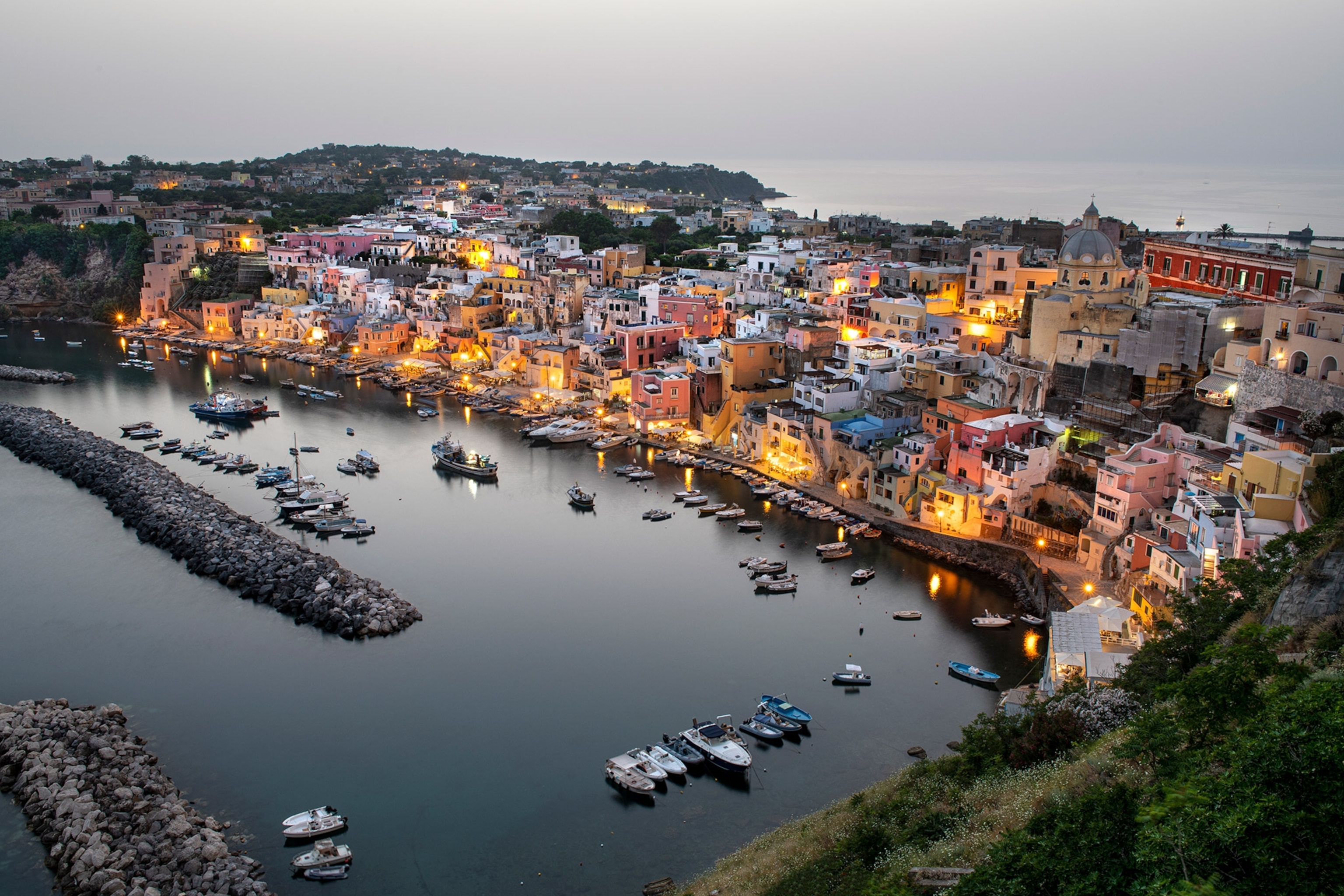 The coast of Procida lit up at twilight