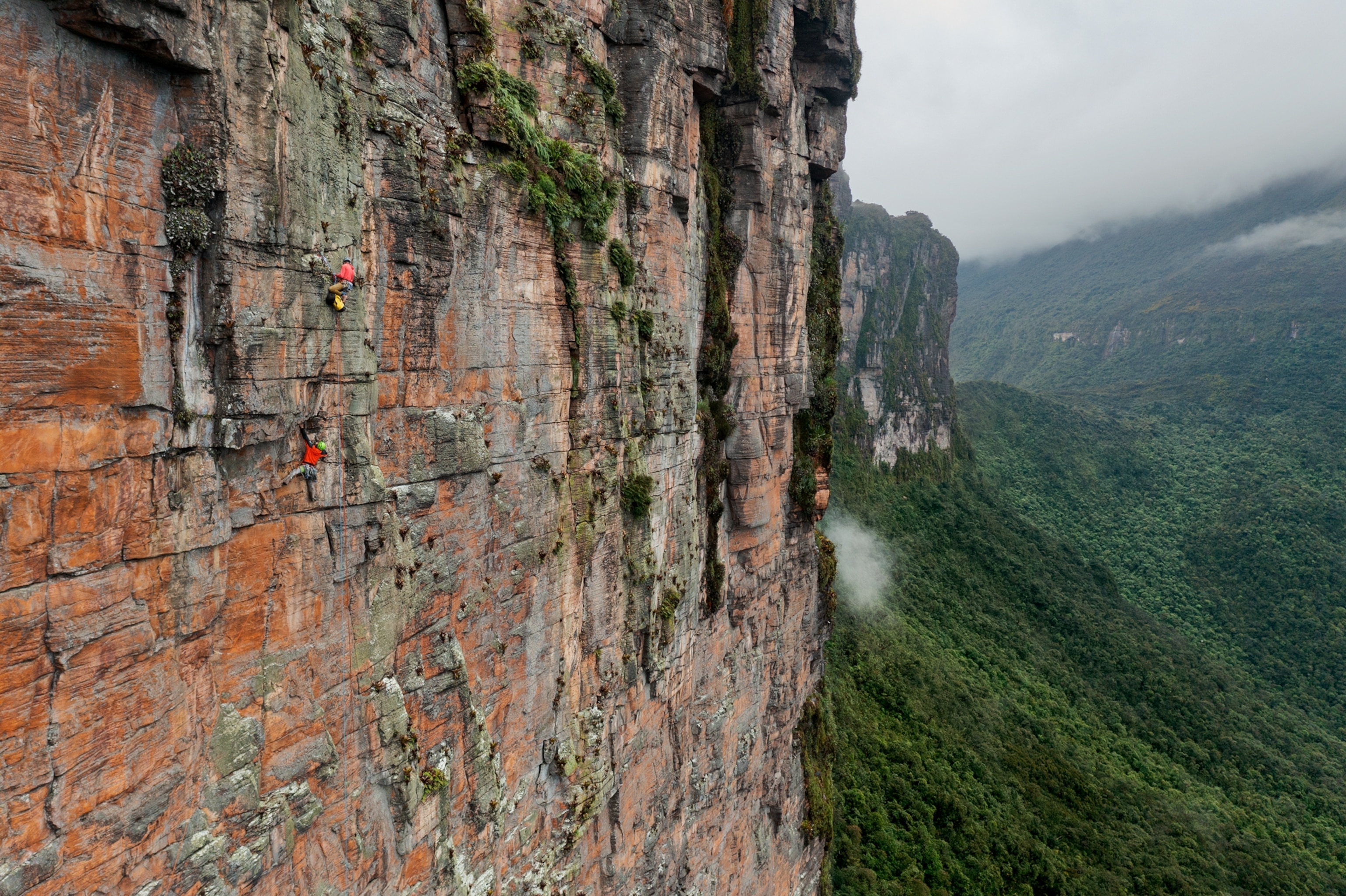 Picture of two persons on vertical cliff face.