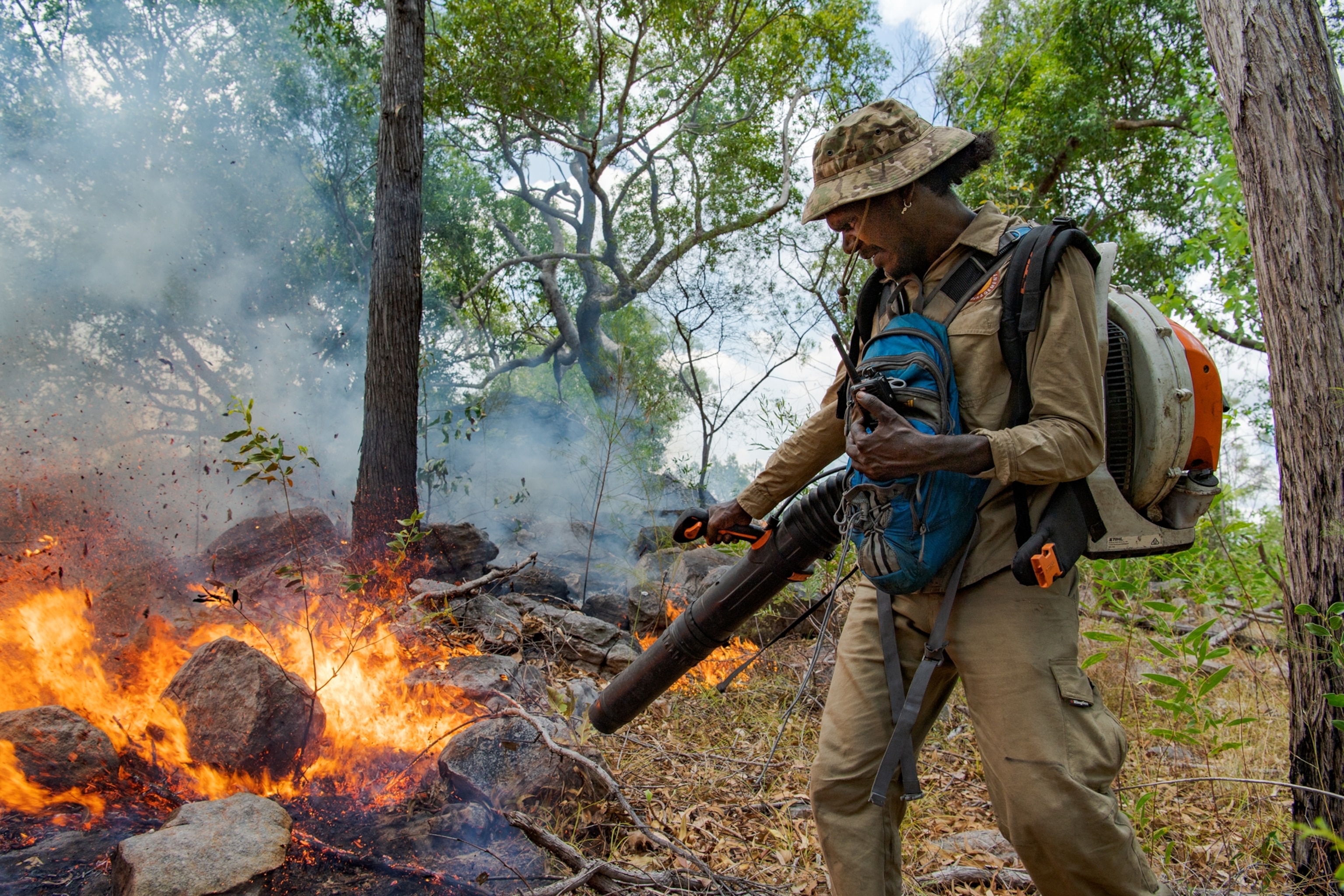 Picture of man extinguishing fire with blower.