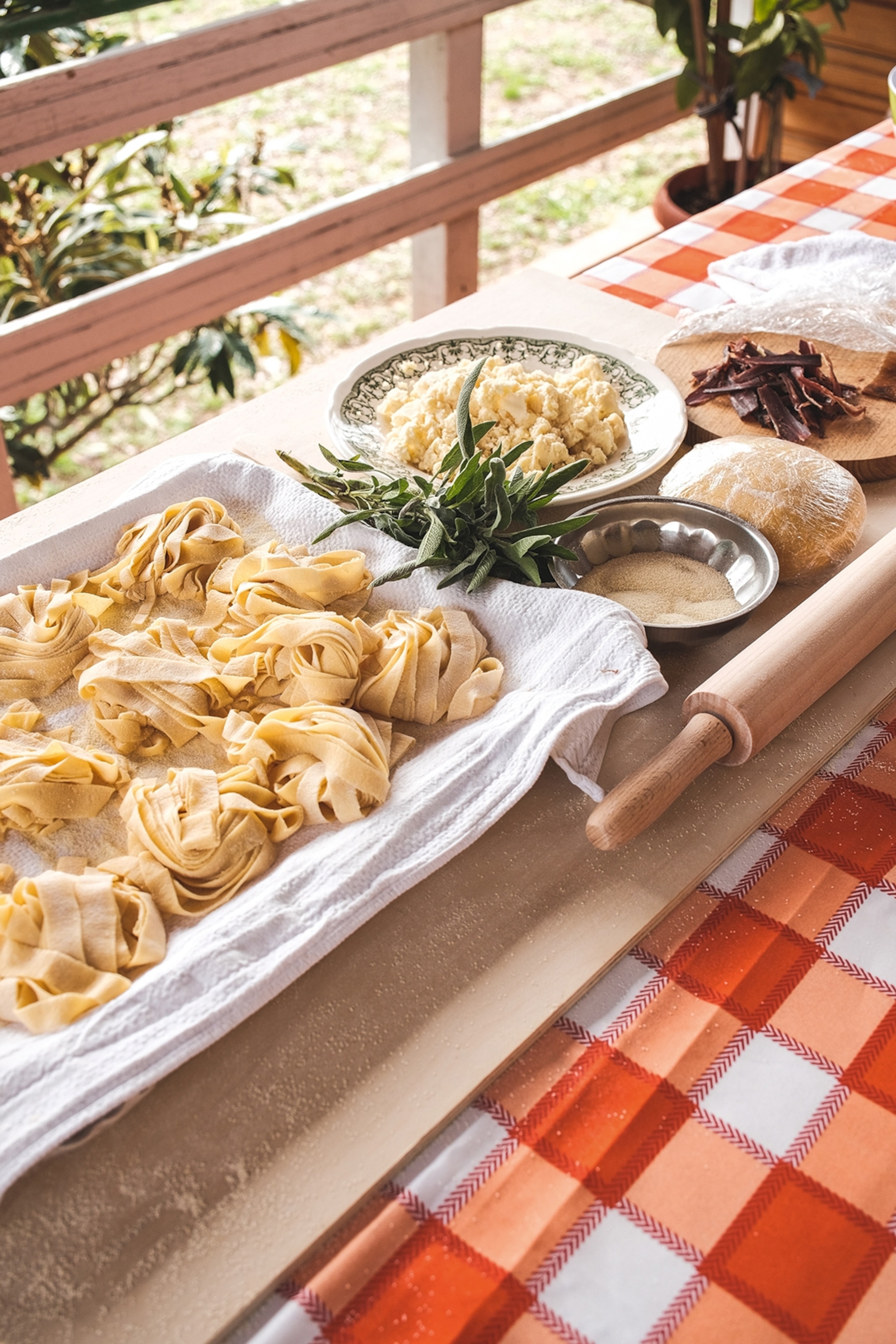 Fresh pasta dough in bowls next to a rolling pin