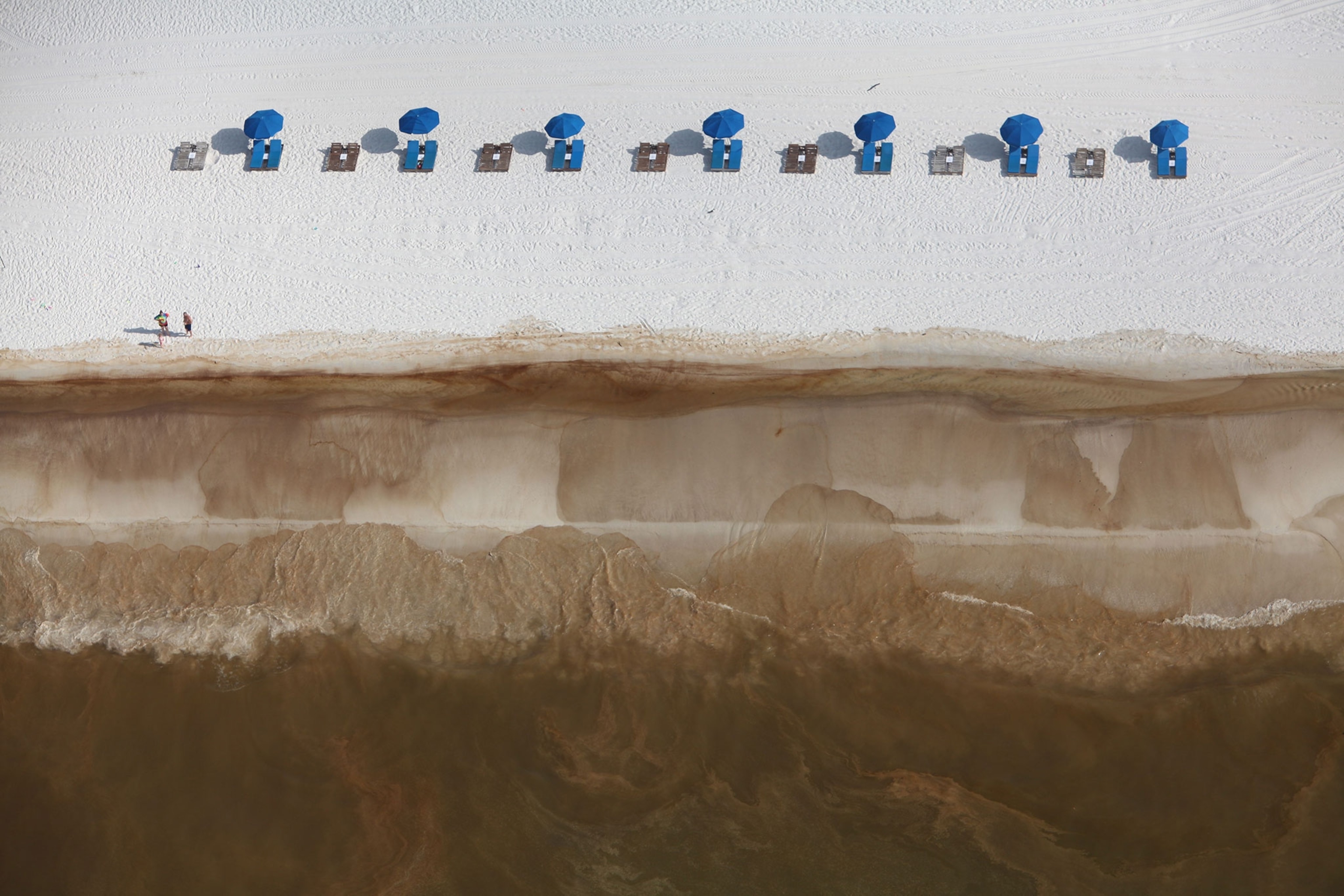 oil-covered white sand beach