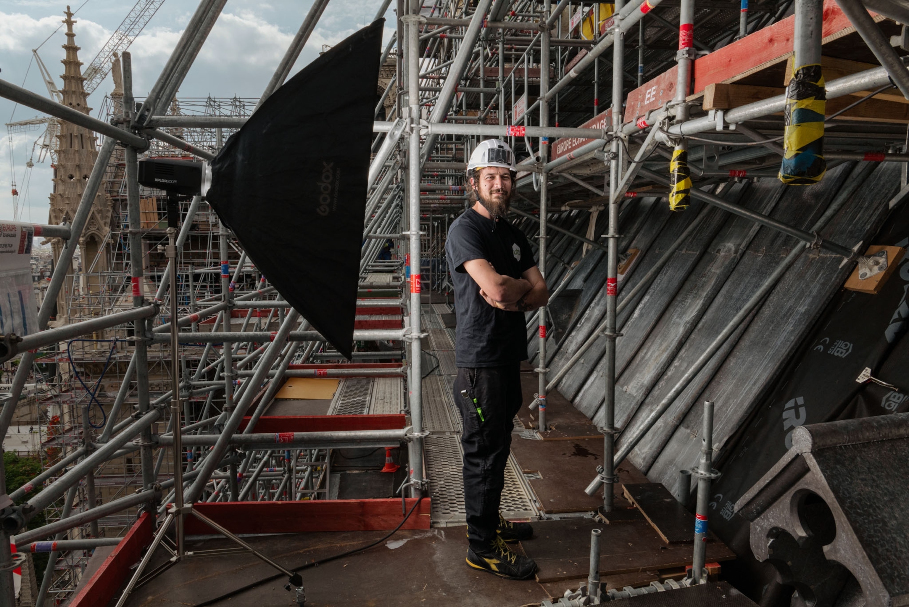 Quentin Attyasse stands beside the ongoing progress of the roof.