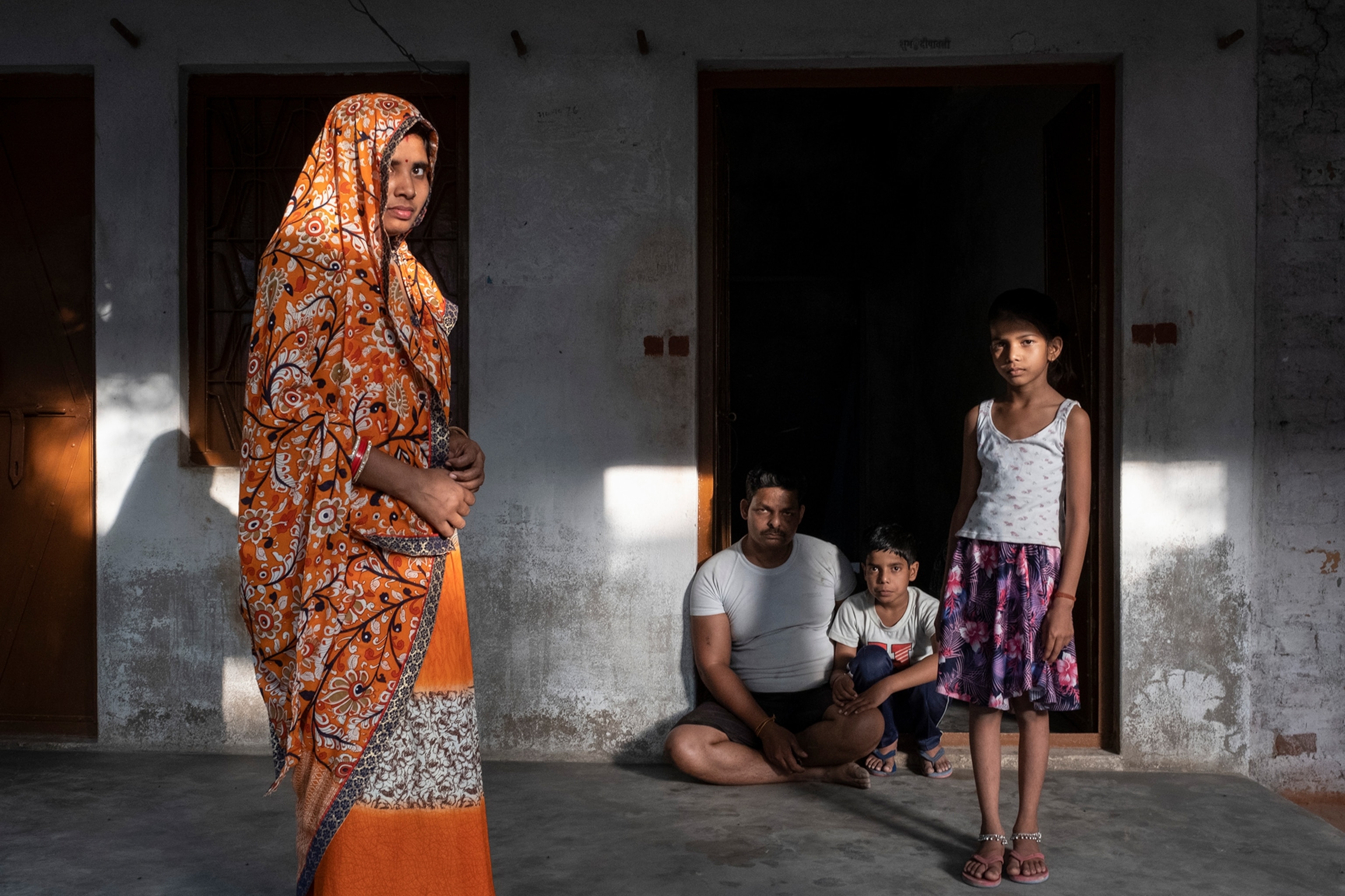 a migrant worker family outside their home