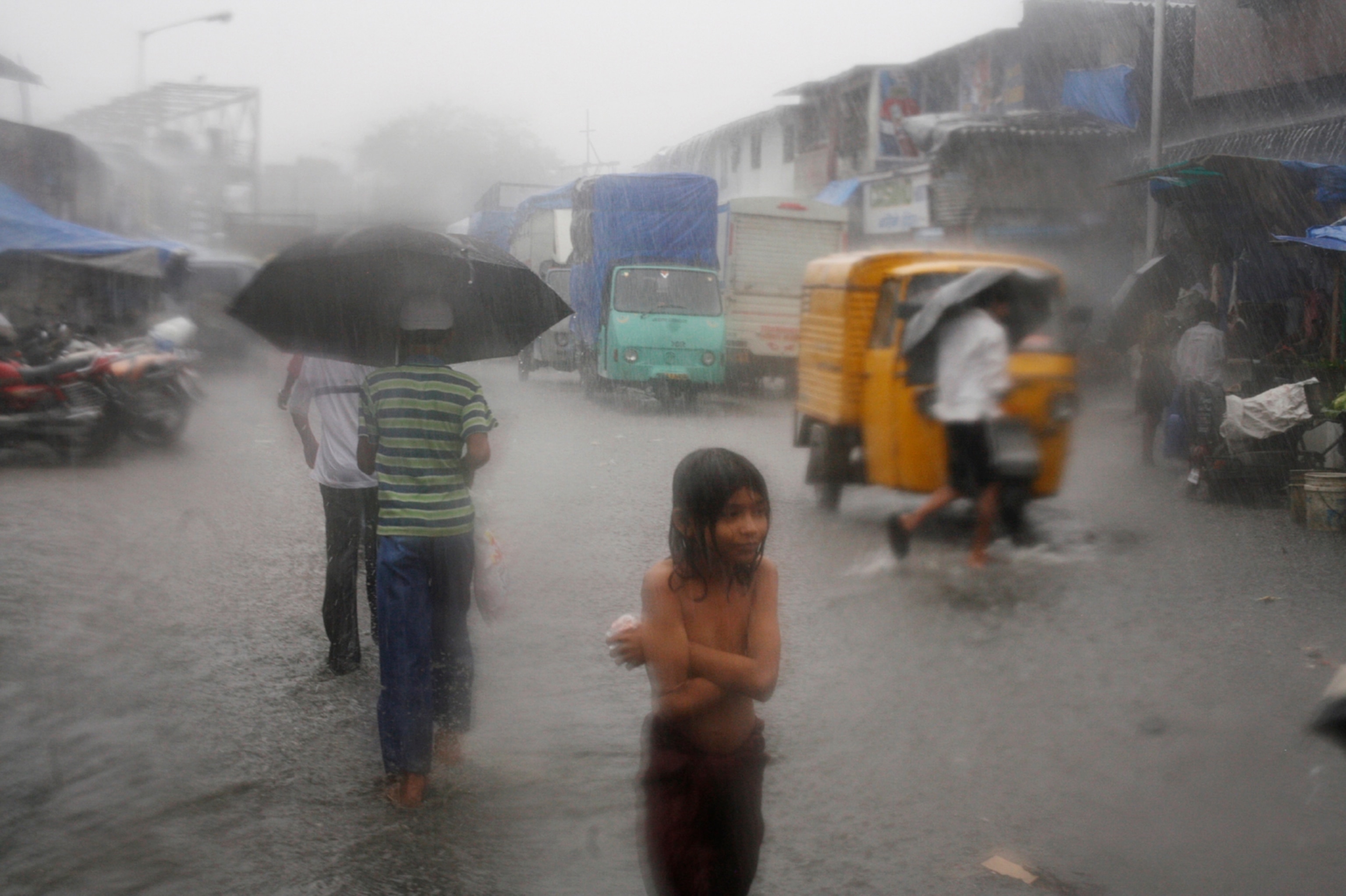 hard rain drenches the streets of Dharavi
