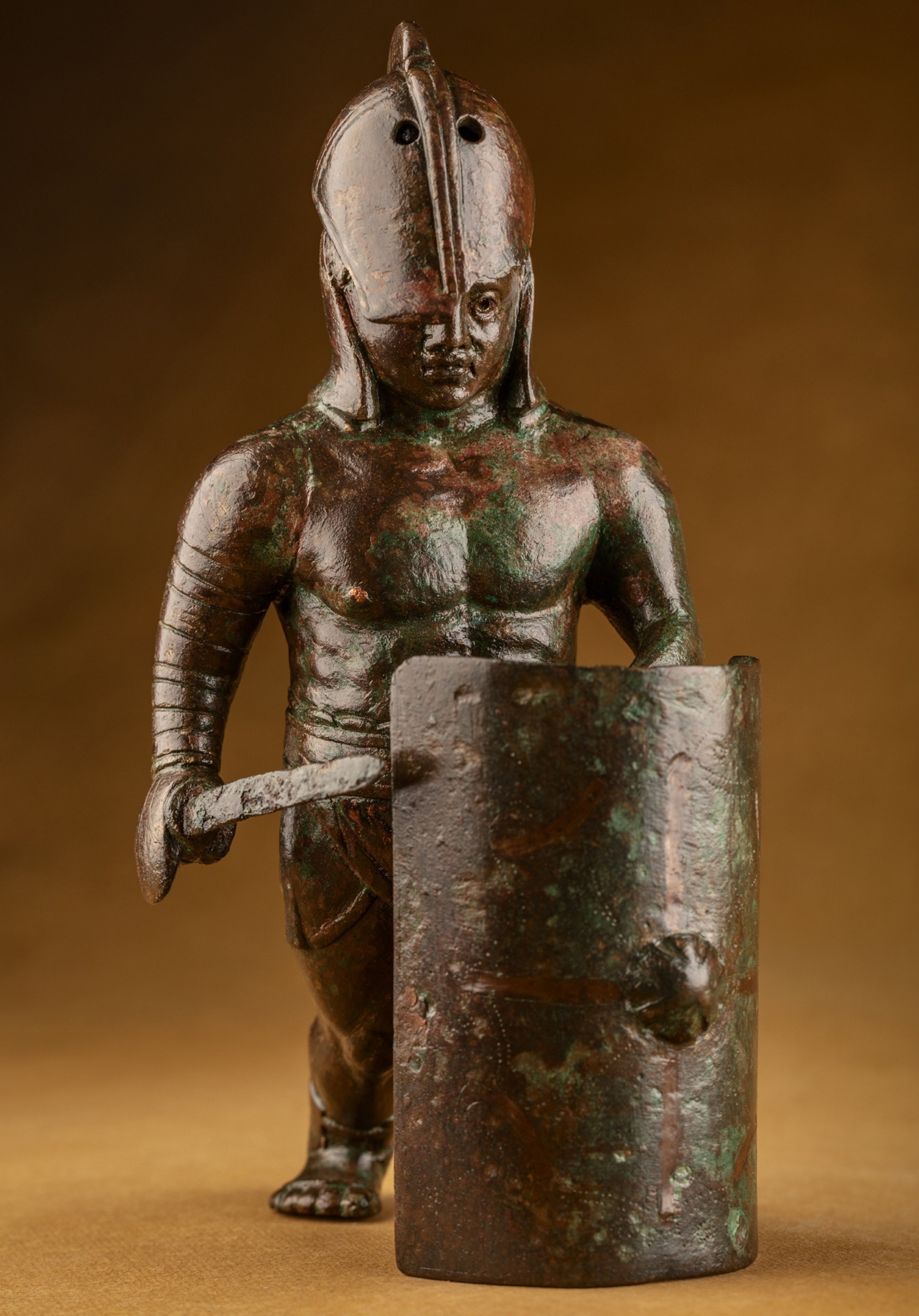 Picture of statuette of gladiator in helmet with sword and shield