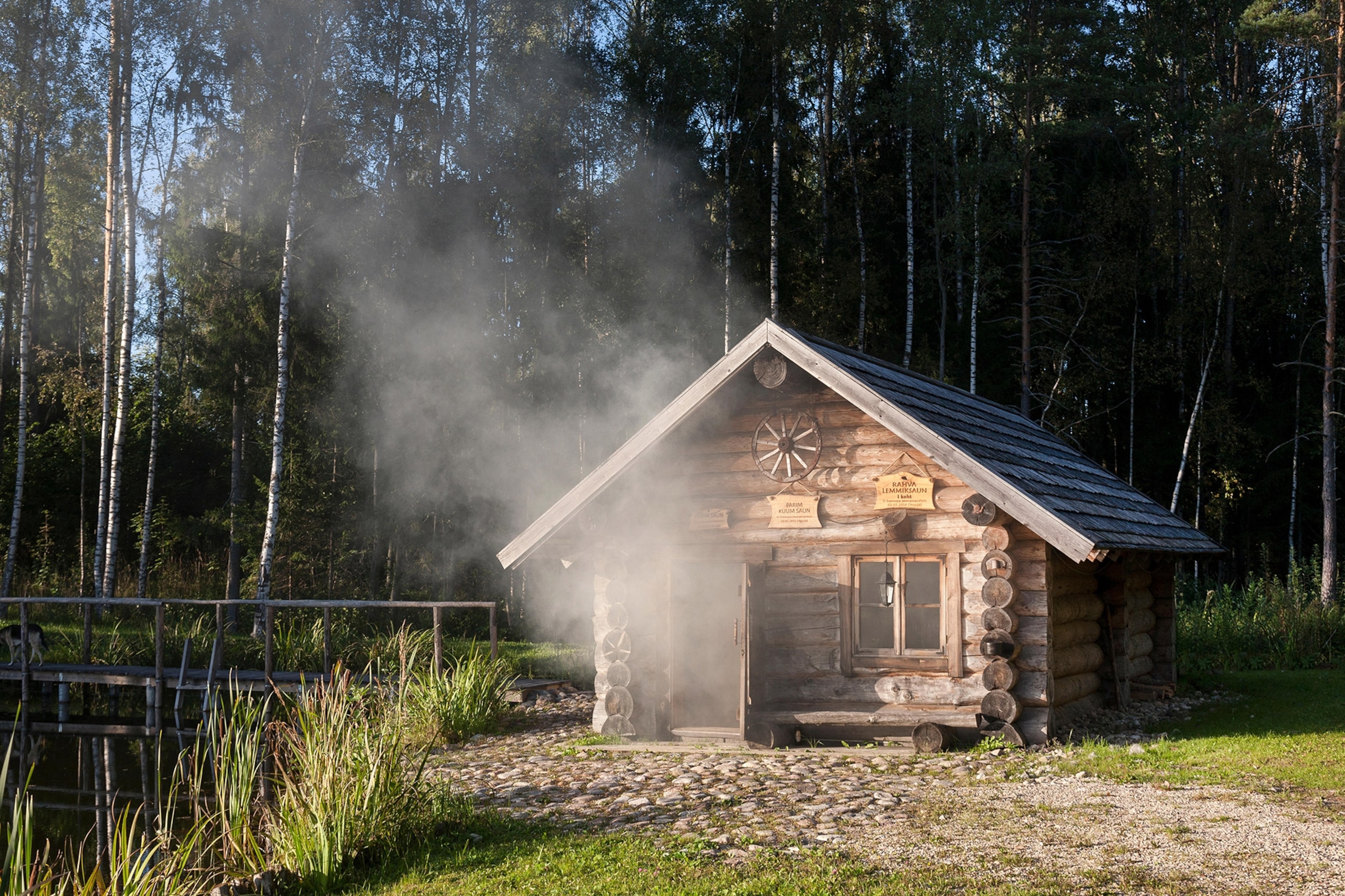 Smoke billows outside of a cabin.