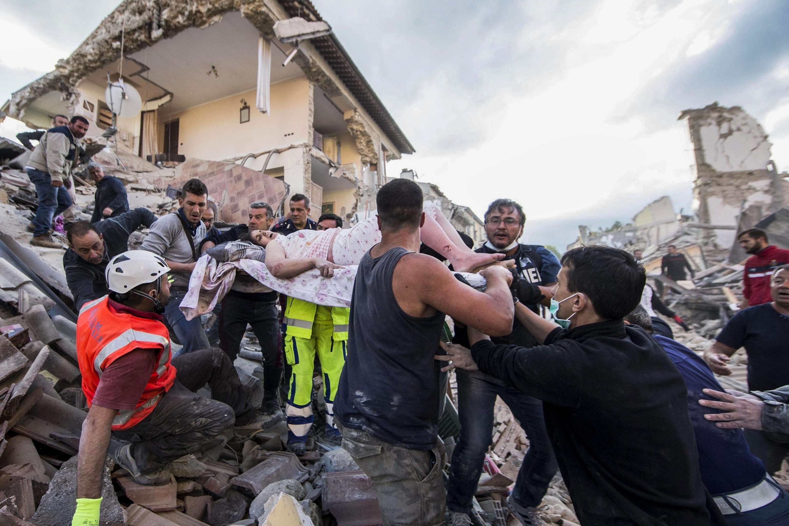 a woman being rescued after an earthquake in Italy