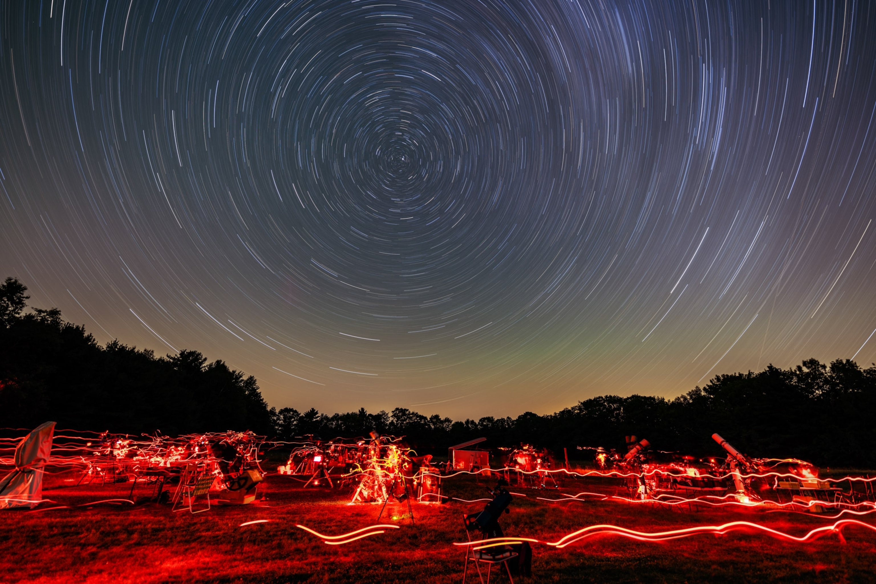 Stars leave light streaks in the sky.