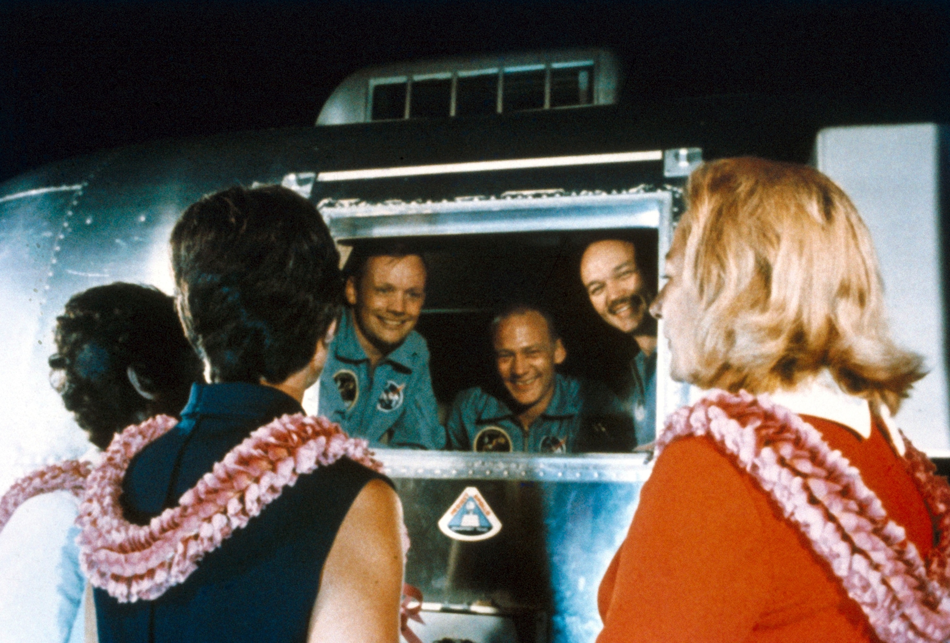 men in a trailer and women looking in