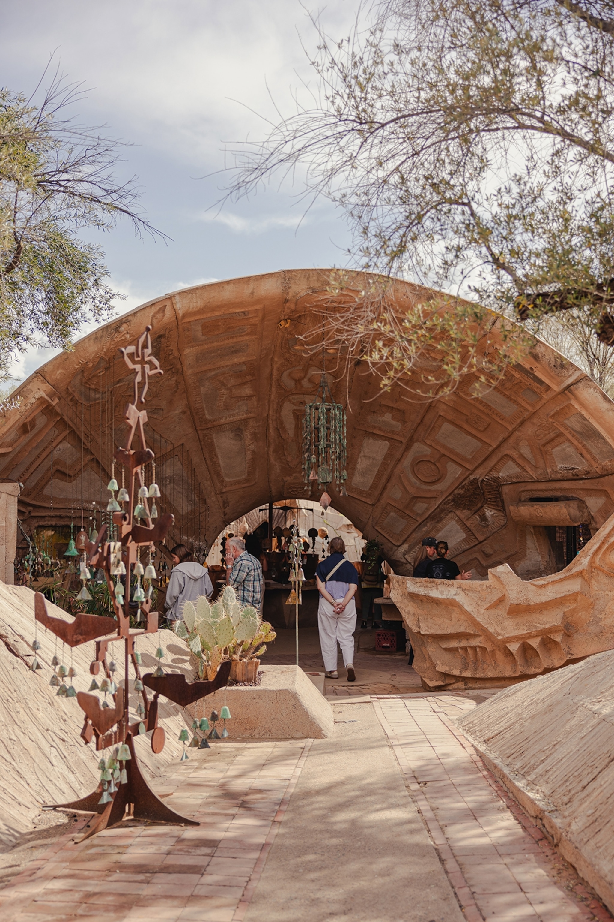 Shoppers in a homeware store in Arizona with a reddish intricate exterior with irregular carvings.