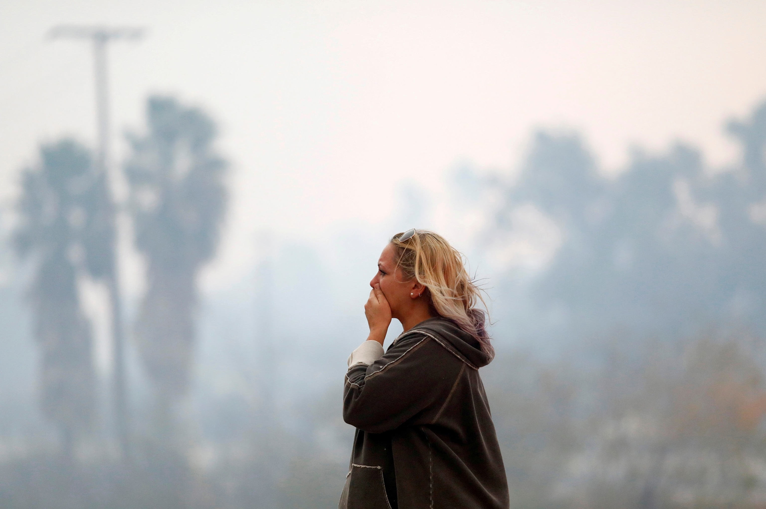 a woman reacting to the Woolsey Fire