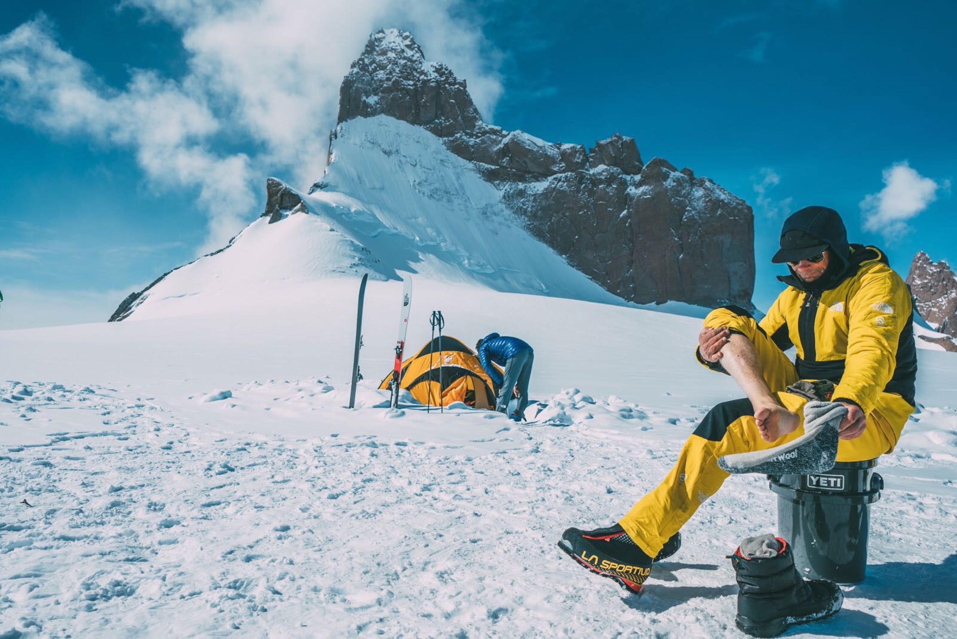 climber Conrad Anker adjusting his climbing gear