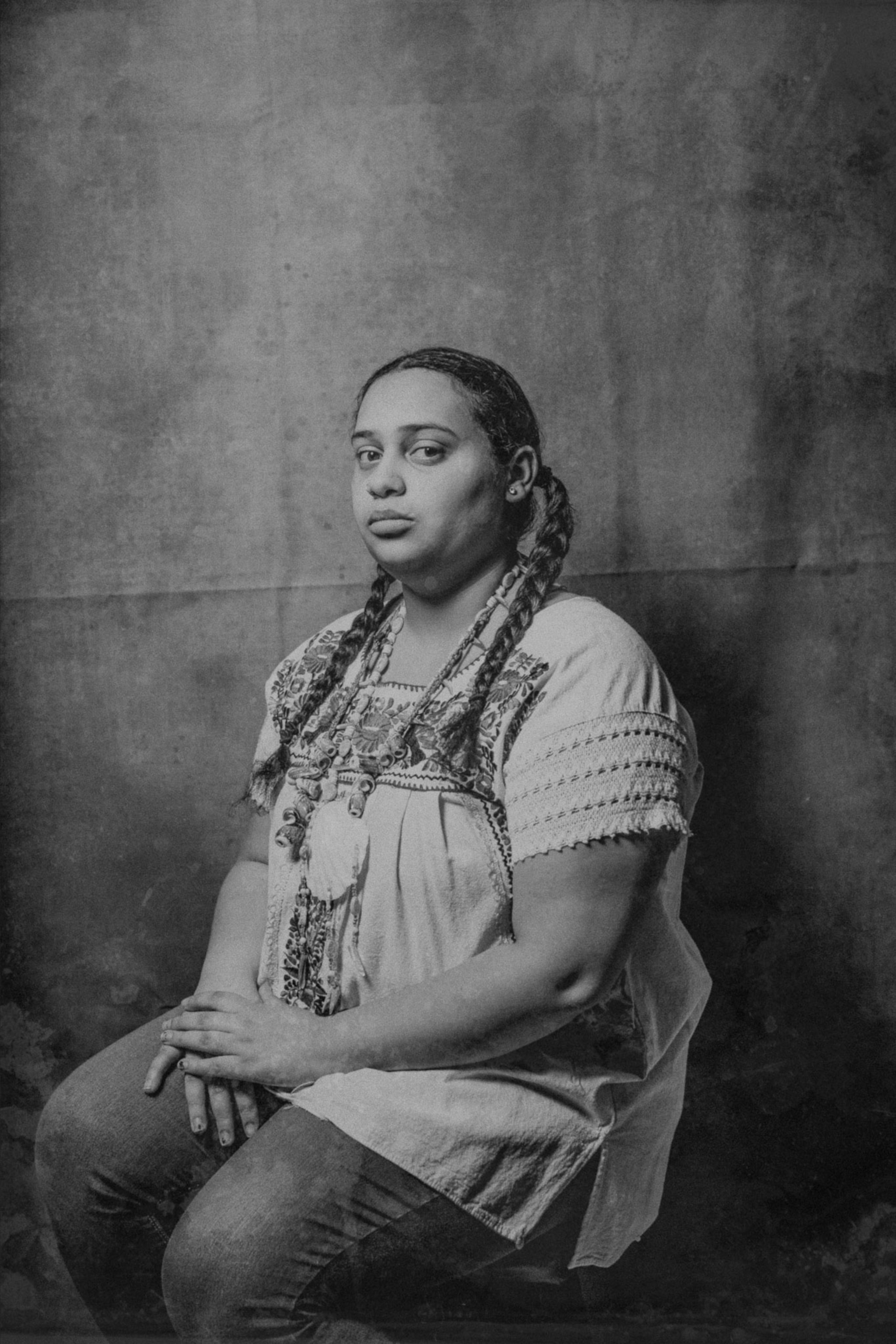 a Taíno person sitting for a portrait