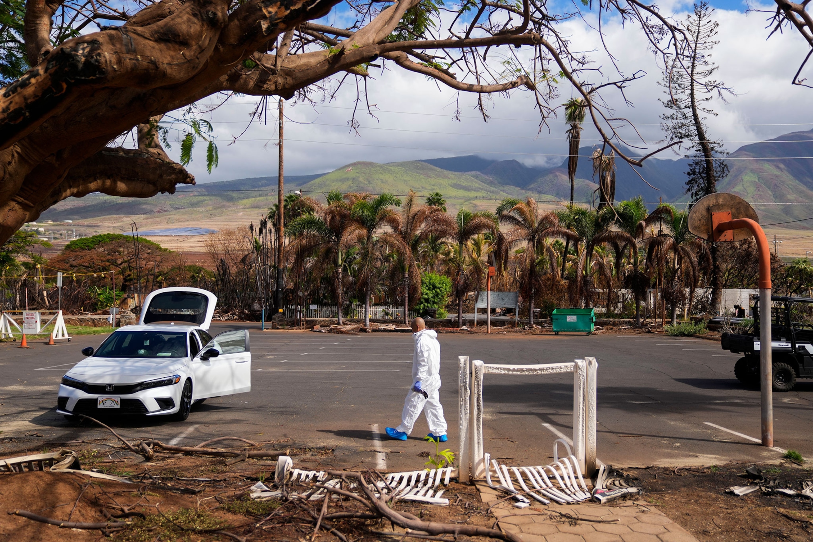 The Rev. Ai Hironaka, resident minister of the Lahaina Hongwanji Mission, walks in the parking lot as he visits his temple and residence destroyed by wildfire