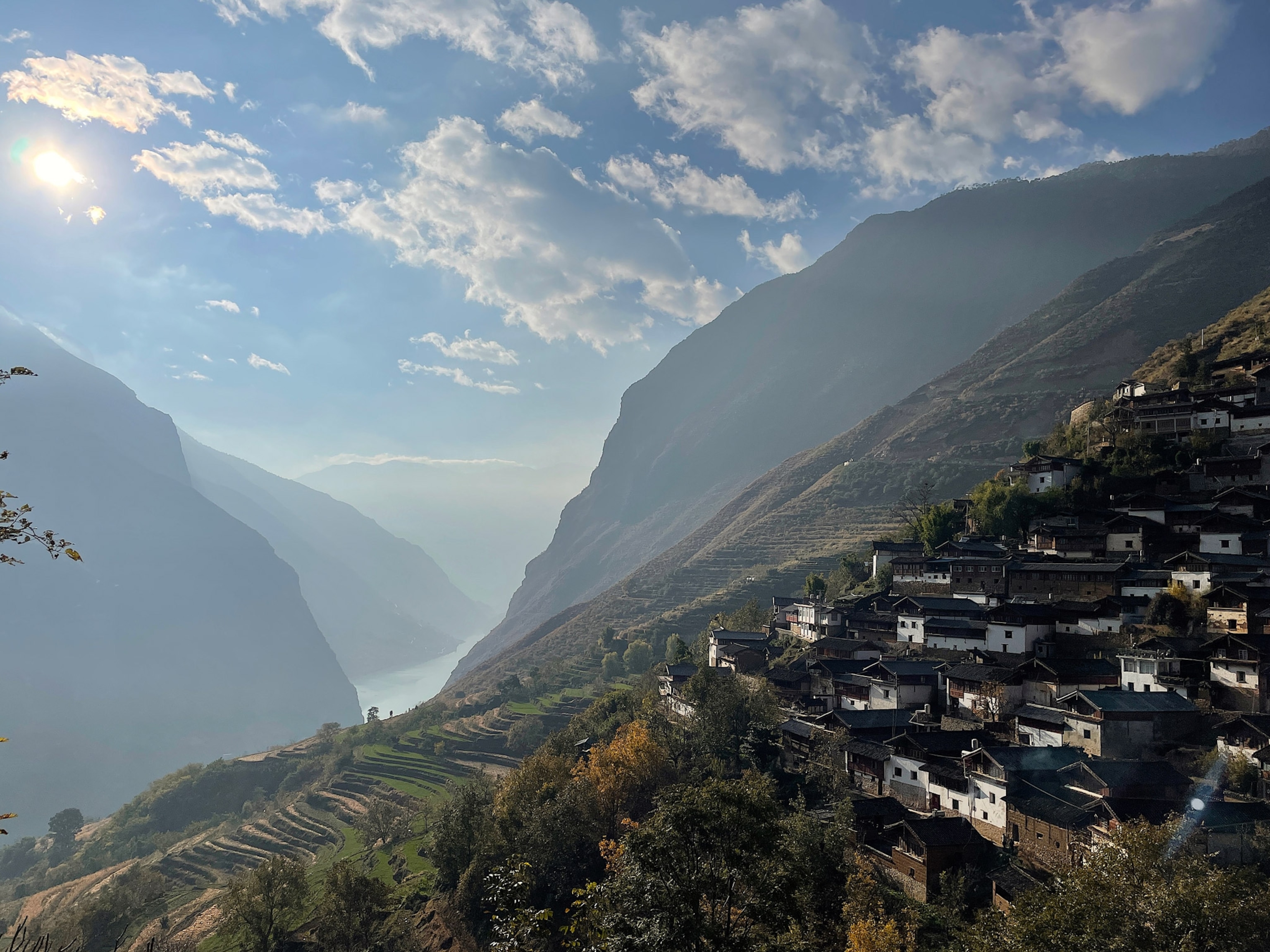 Photo of mountain range with small houses on one side.