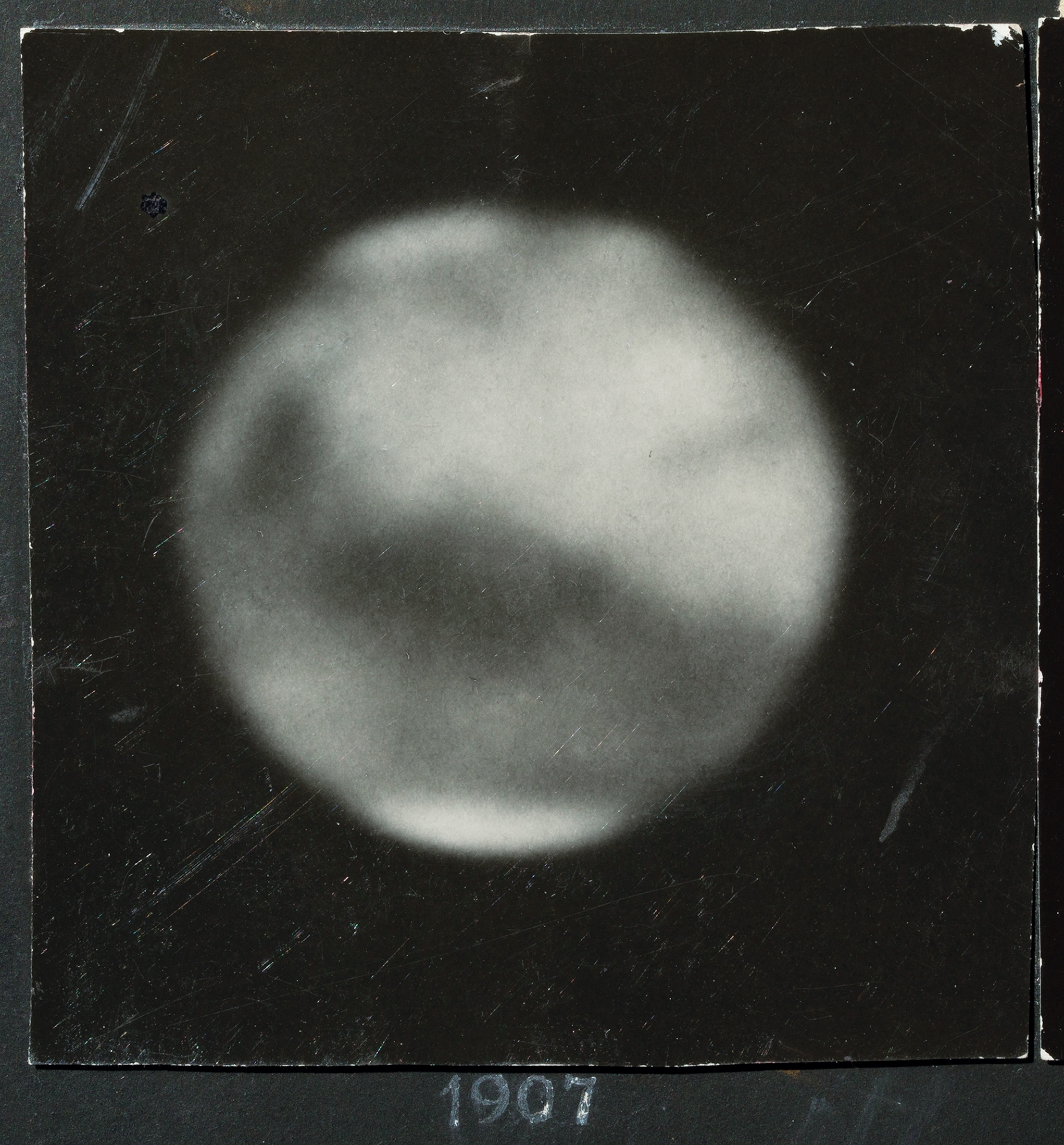 blurry photograph of Mars surface with dark spots.