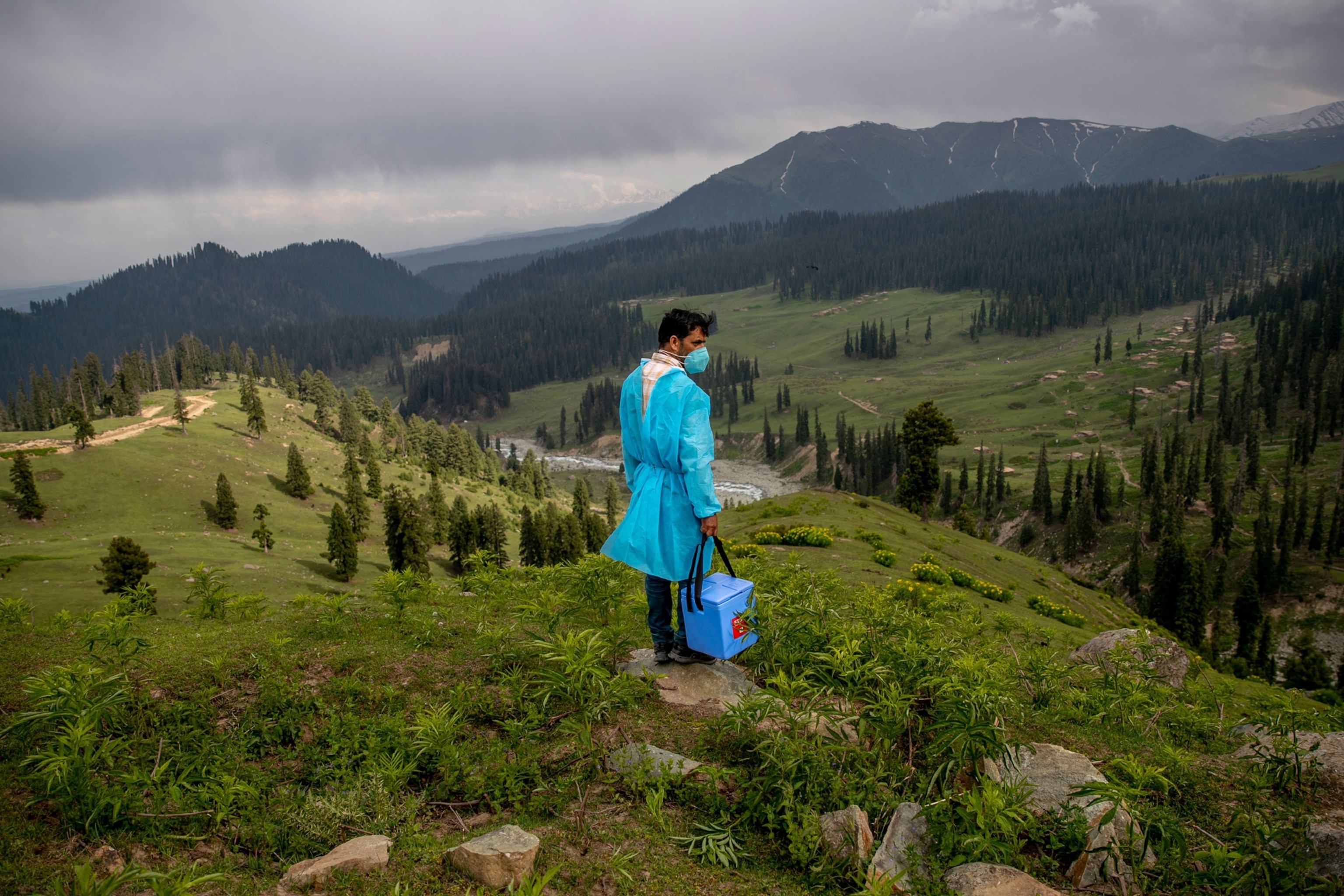 Healthcare worker looks out from a hill