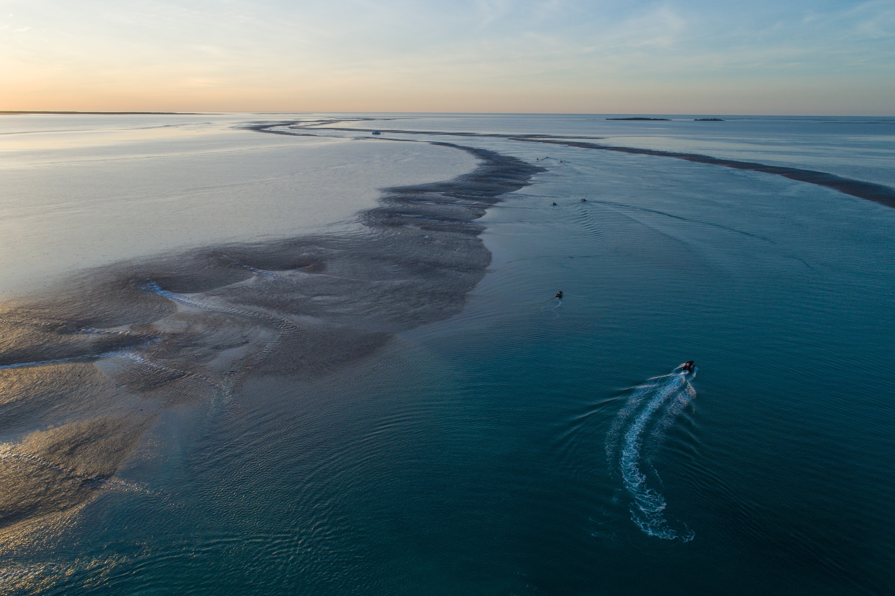 Aerial view of a boat moving through low tide at Montgomery Reef on the Kimberley Coast