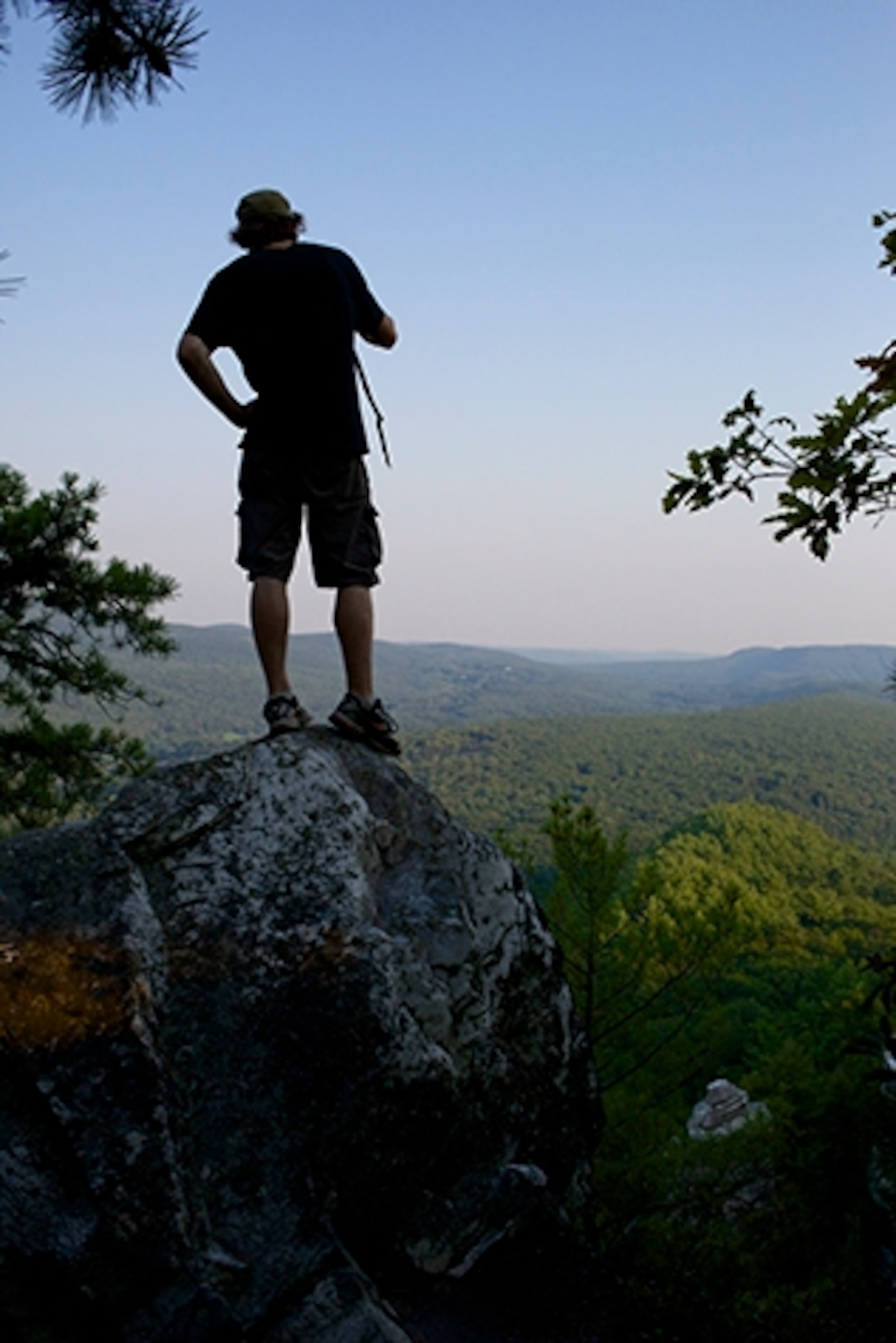 A hiker looks out from the Devil's Pulpit on Monument Mountain, which overlooks the countryside of neighboring states Vermont and New York. (Photograph by Jodi Hilton)