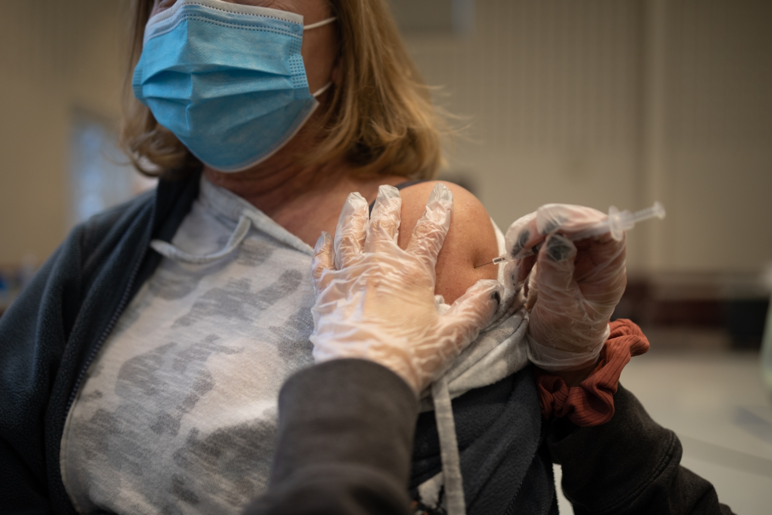 Picture of a patient receiving a COVID-19 booster shot.