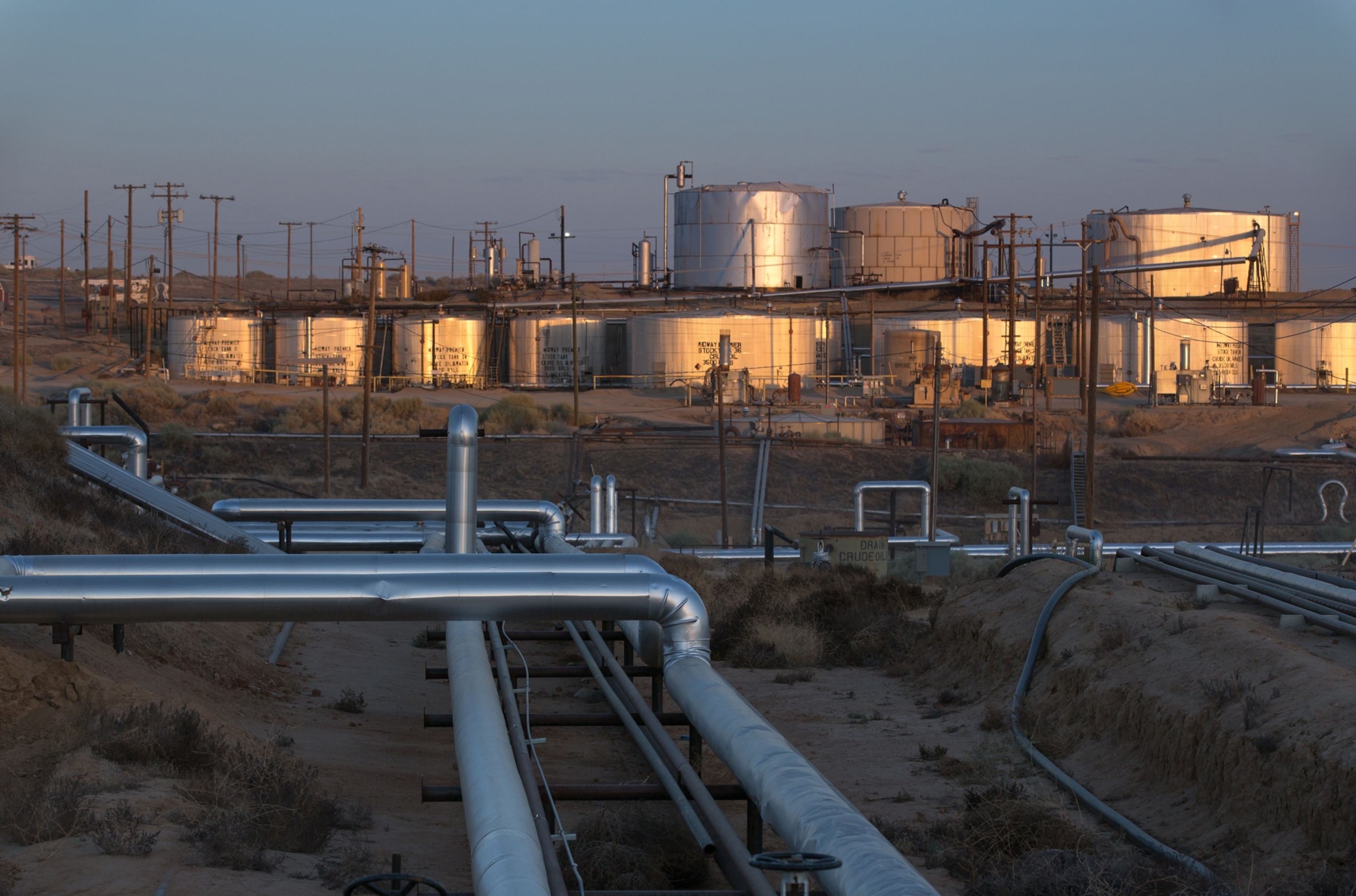 a field of oil wells and storage tanks in California