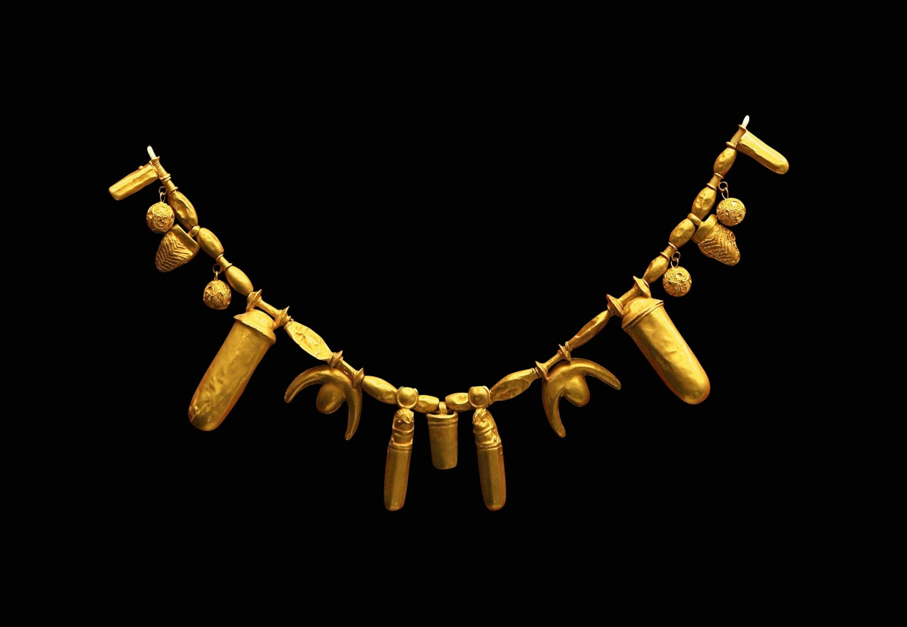 A gold necklace on a black background