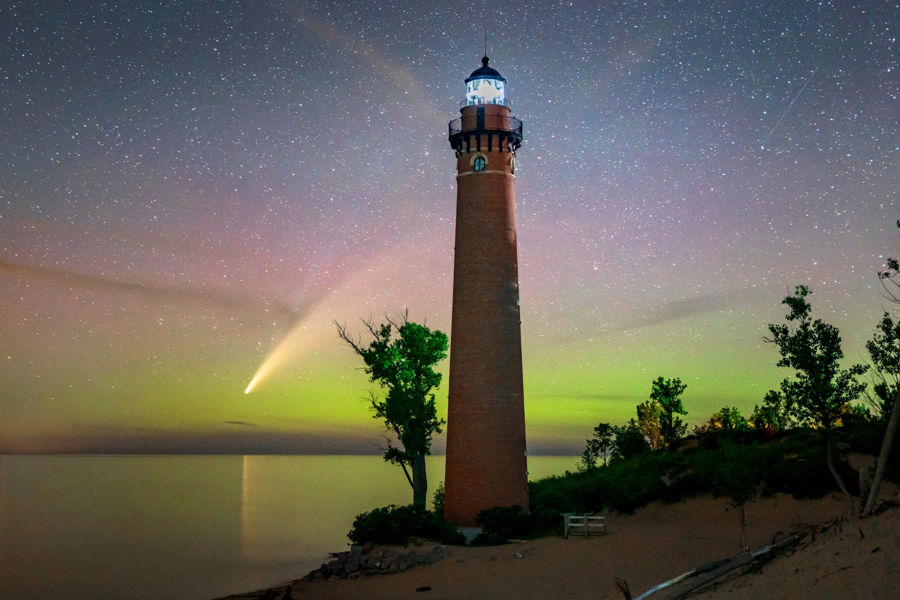 the the comet Neowise over Little Sable Point Light in Mears, Michigan