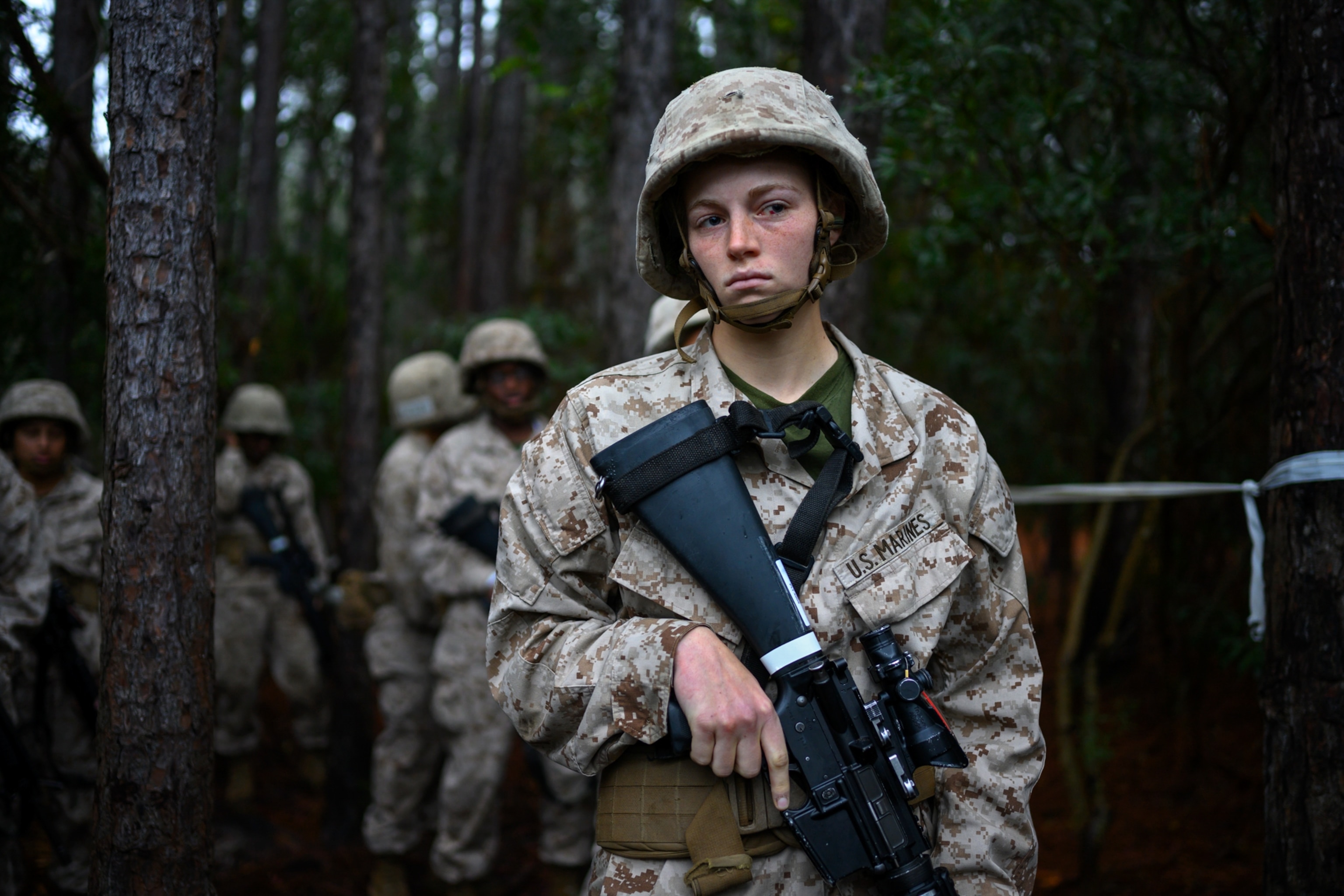 a young woman holding a gun in line