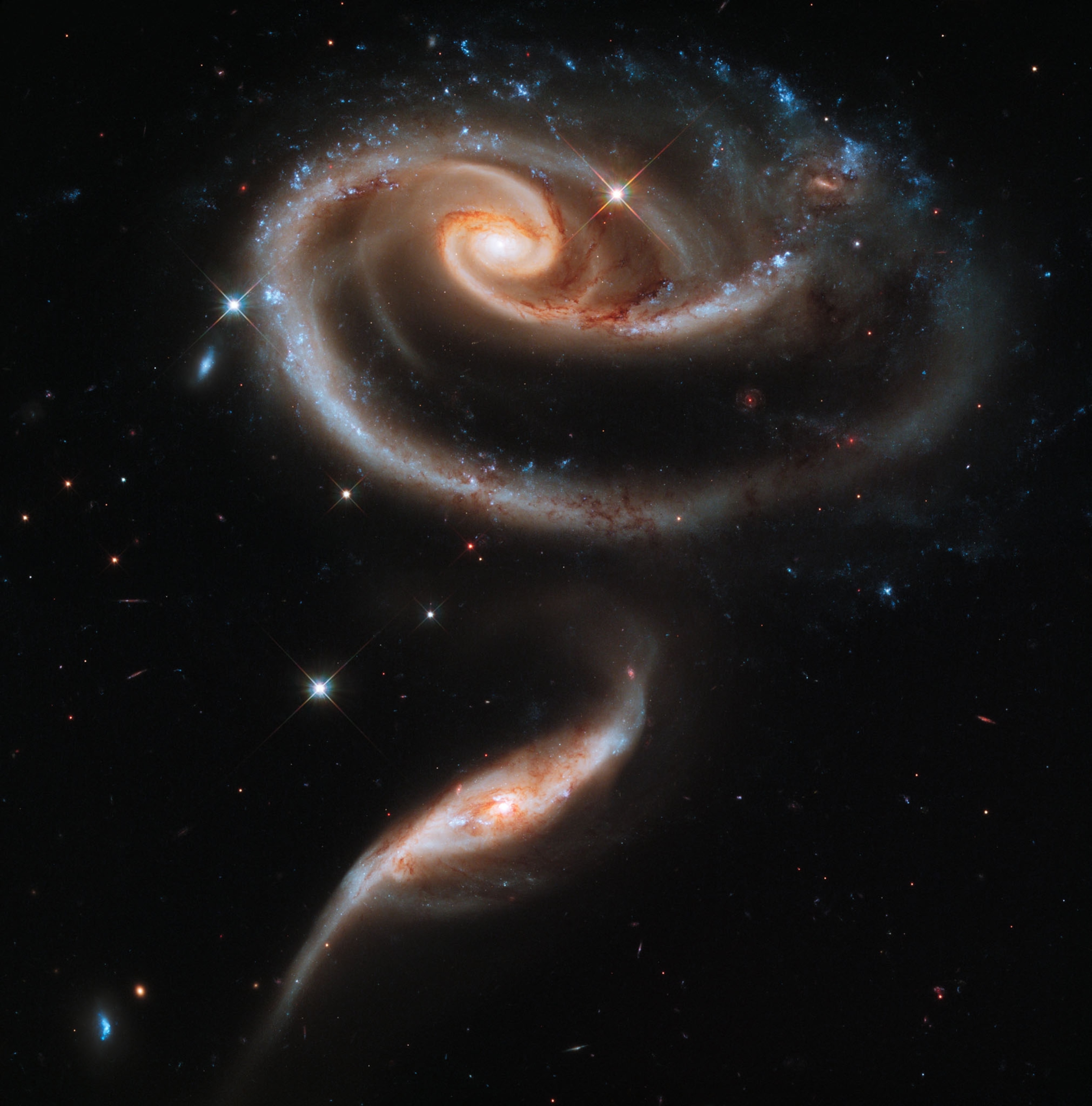 perfect spiral of light on black skies with bright stars.