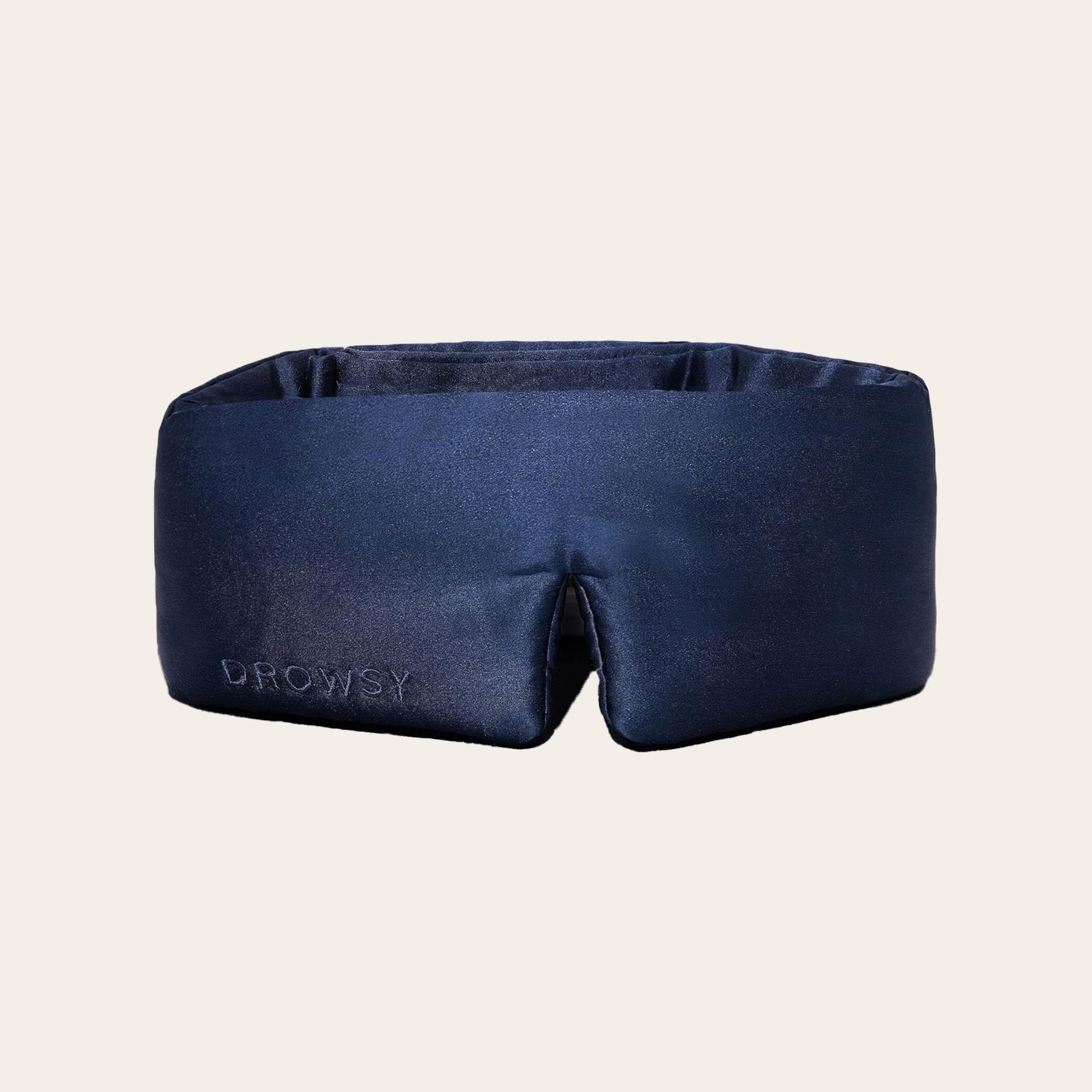 A navy mask on the cream background.