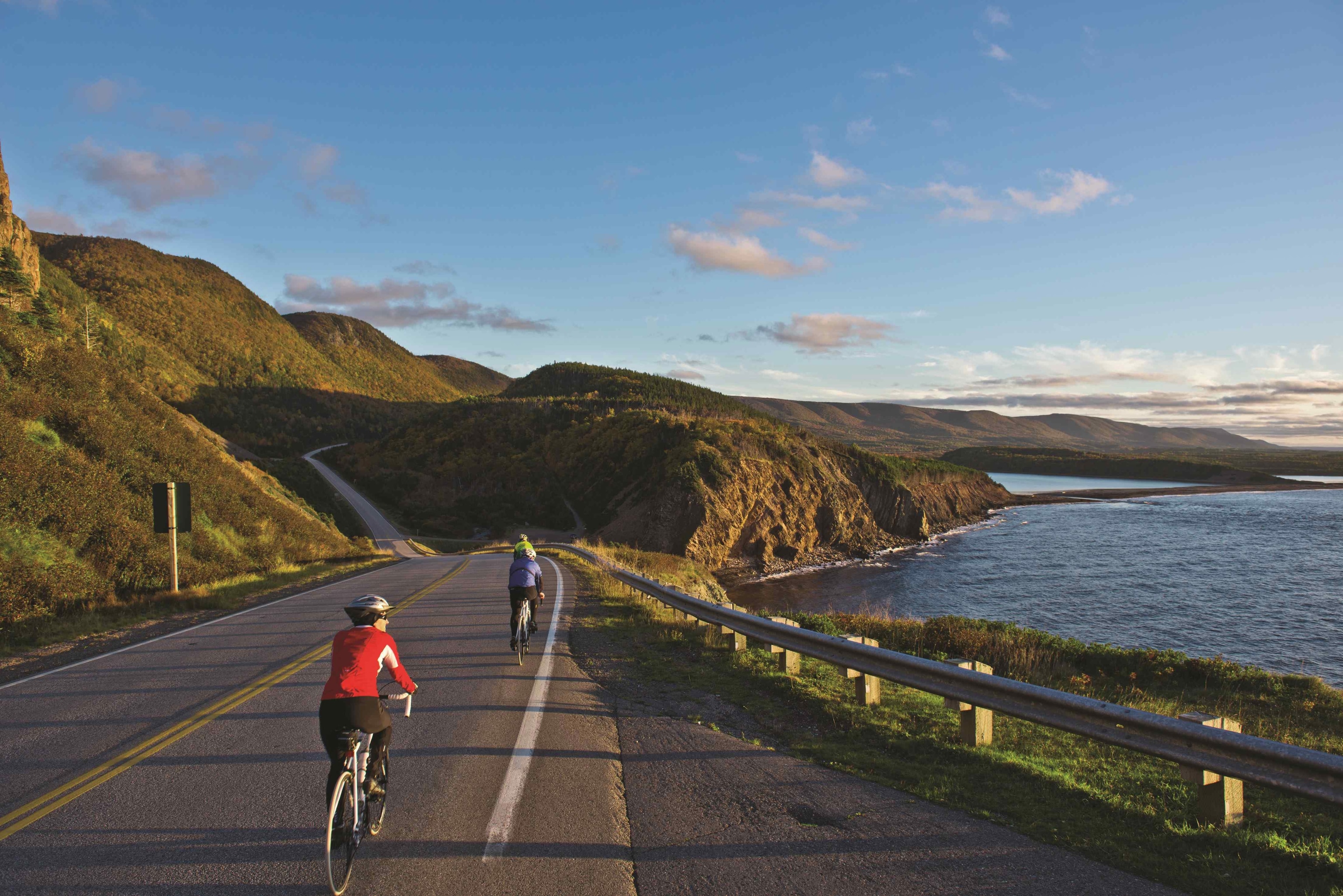 a couple having a bike ride along Cape Breton’s coastline