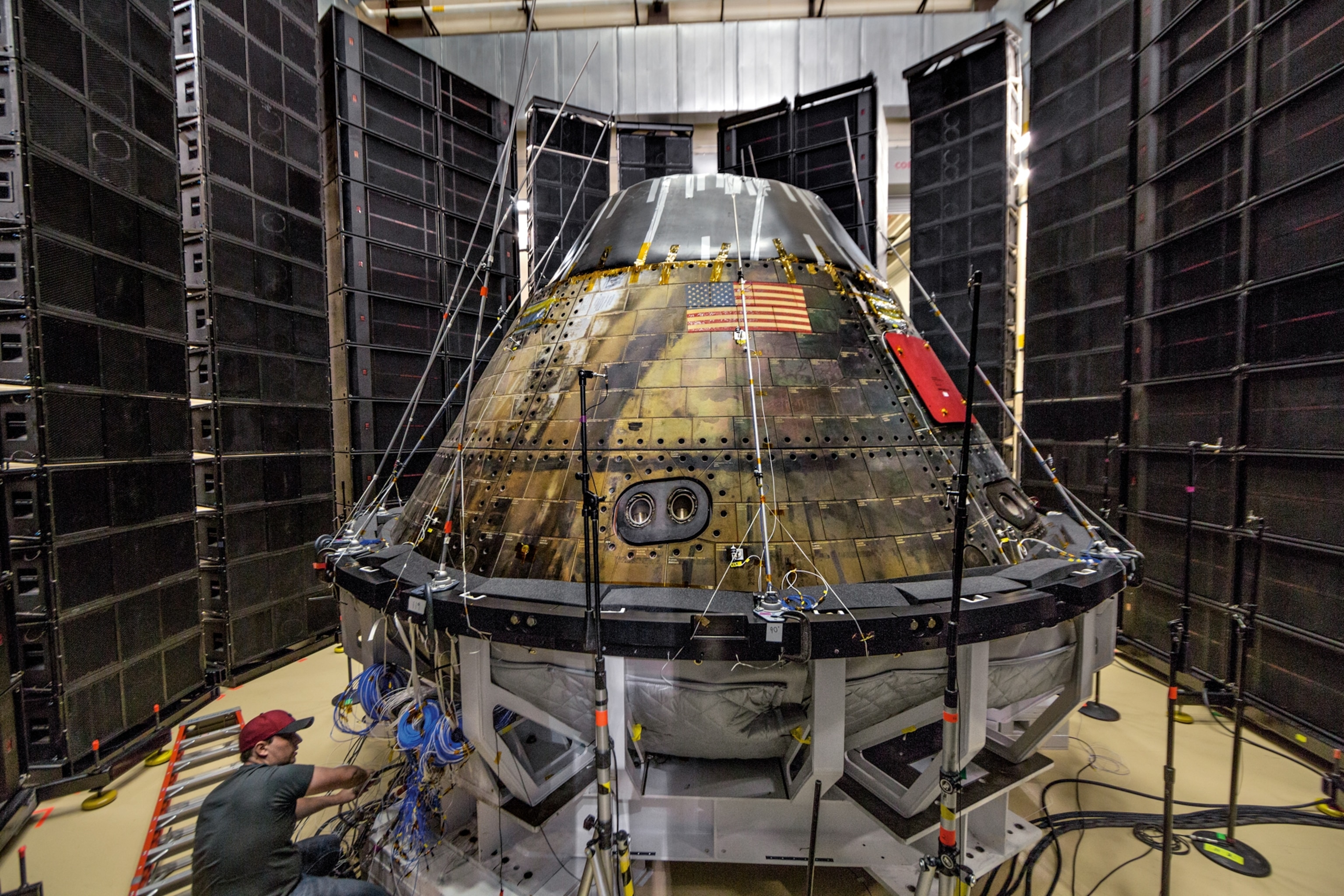 technician preparing Orion crew module for simulated noise blast of a launch.