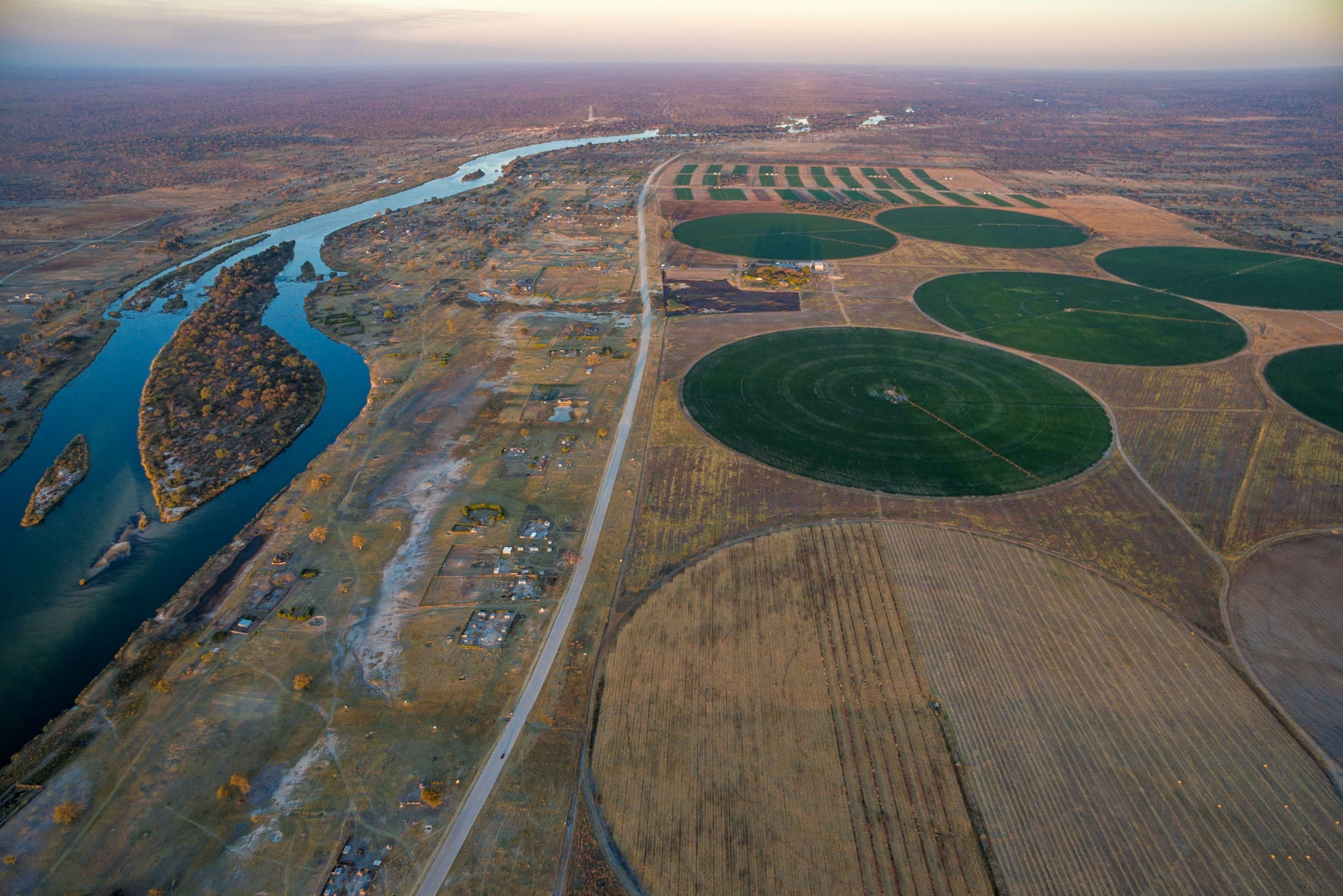aerial view of circular agricultural fields irrigated with water from the Okavango River.