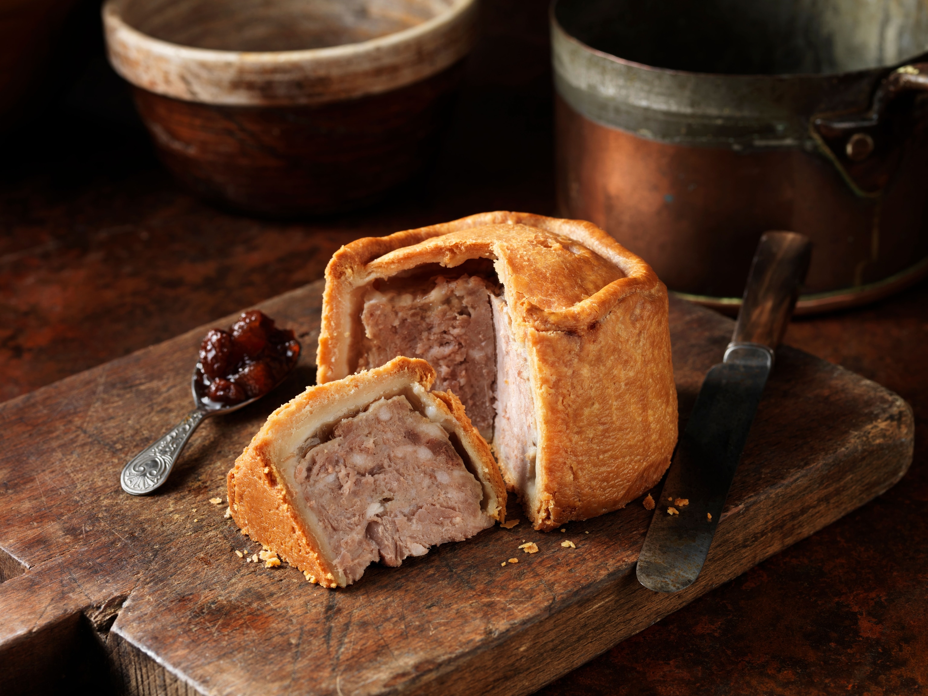 baked pastry sliced open, pork gilling, spoonful of jam at the side