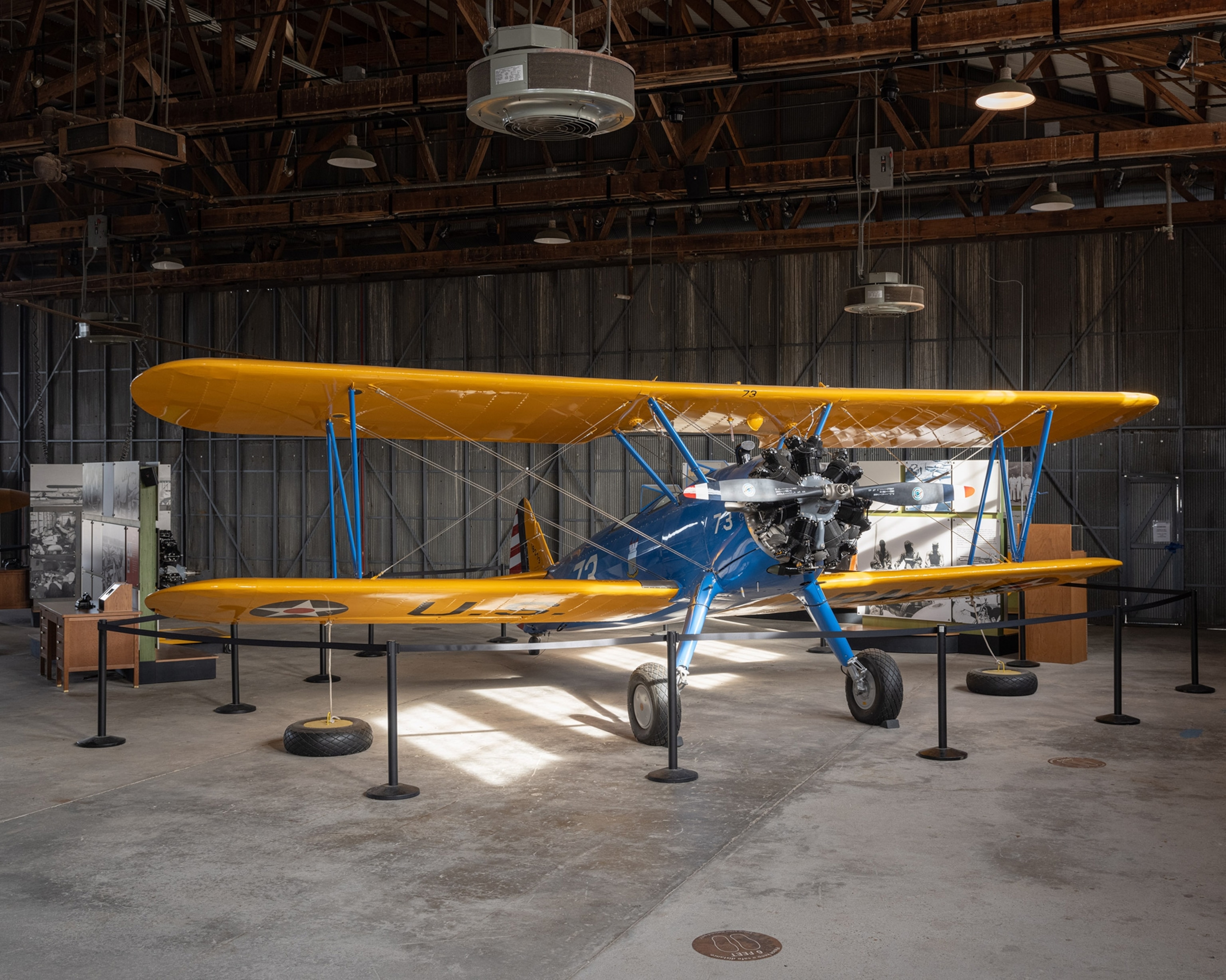 A plane in a hanger illuminated by daylight.